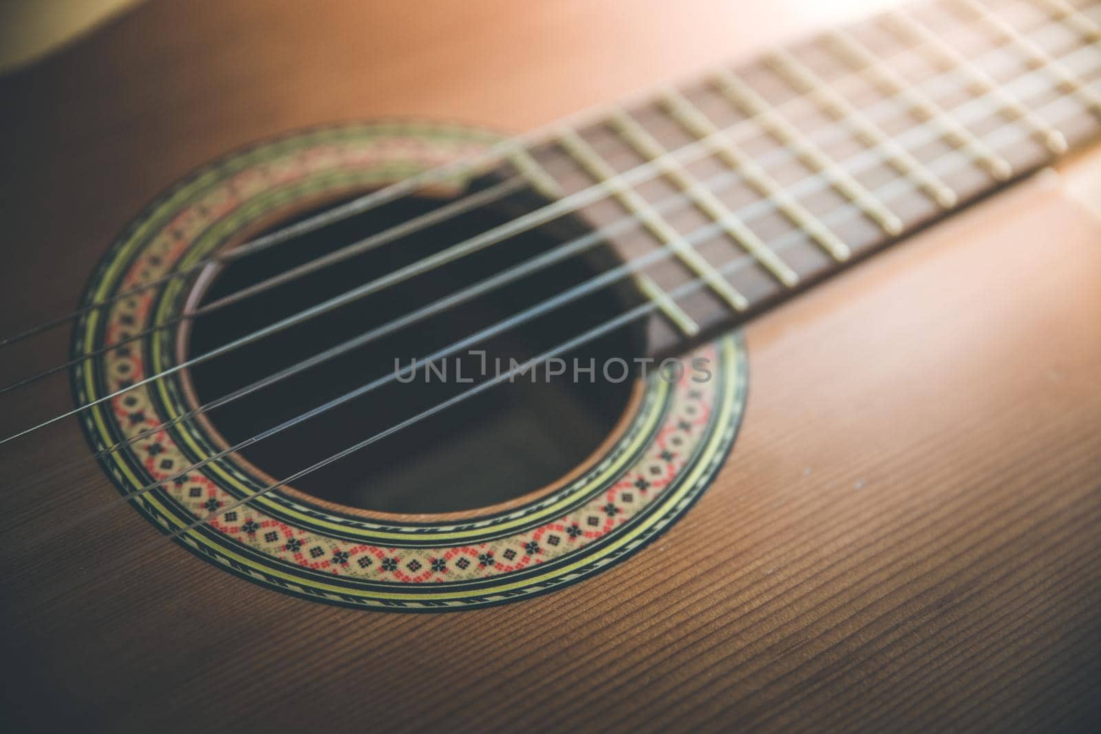 Cutout of a classical guitar corpus and strings, closeup