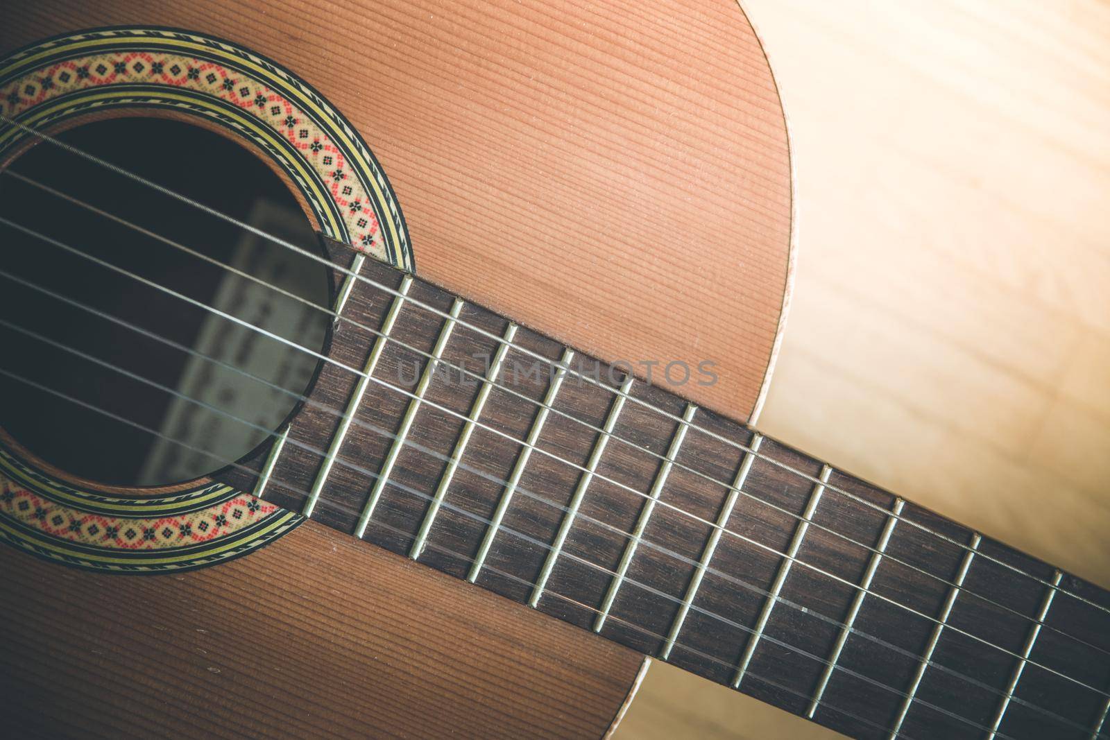 Cutout of a classical guitar corpus and strings, closeup