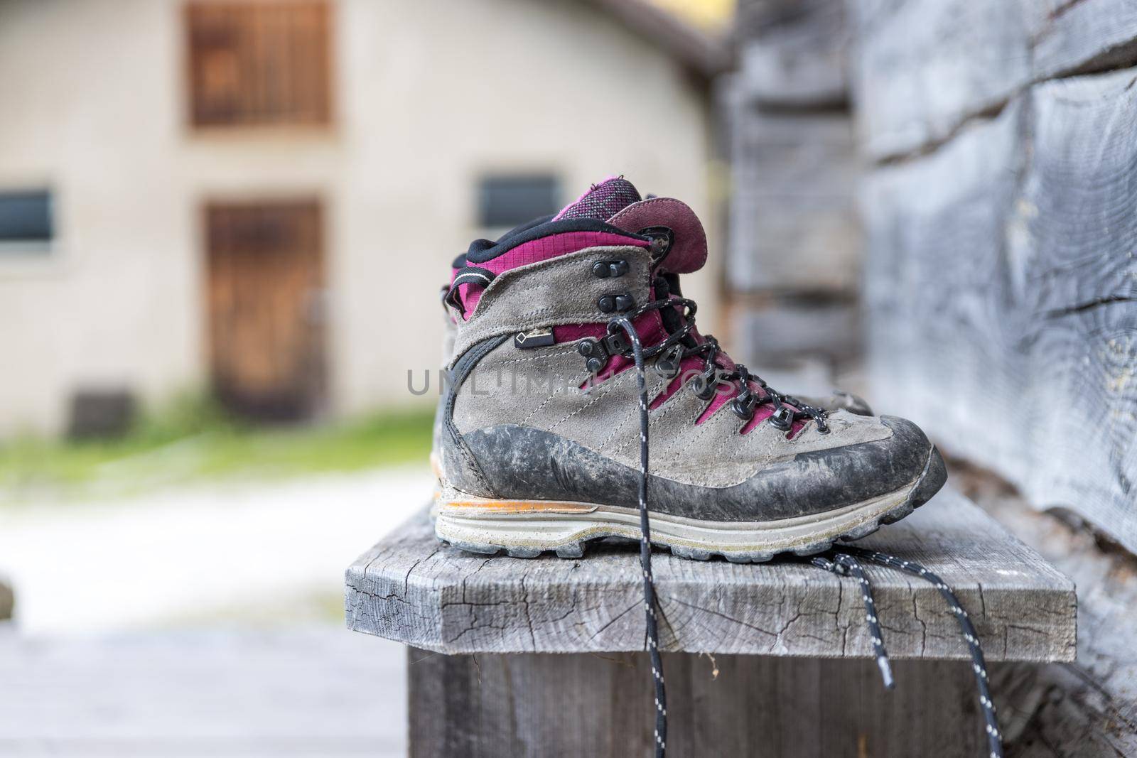 Close up picture of hiking boots on a rustic wooden veranda of an alpine hut