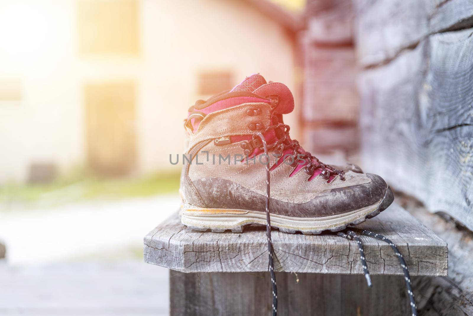 Close up picture of hiking boots on a rustic wooden veranda of an alpine hut