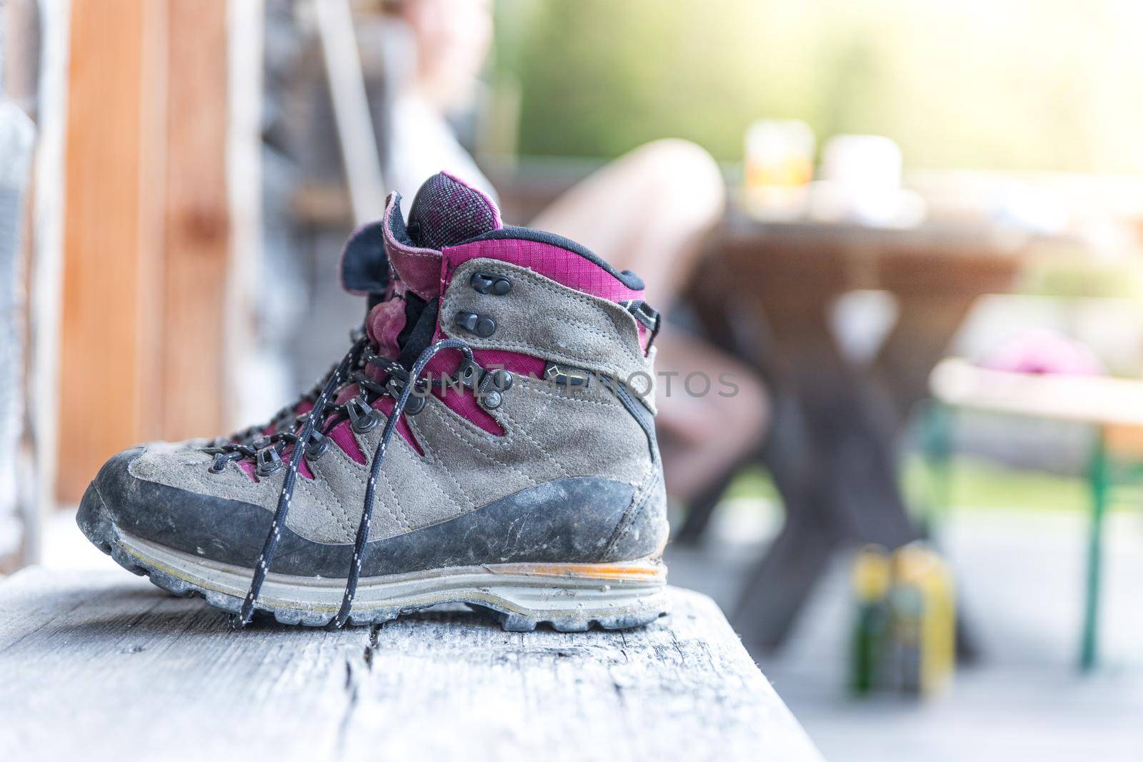 Close up picture of hiking boots on a rustic wooden veranda of an alpine hut