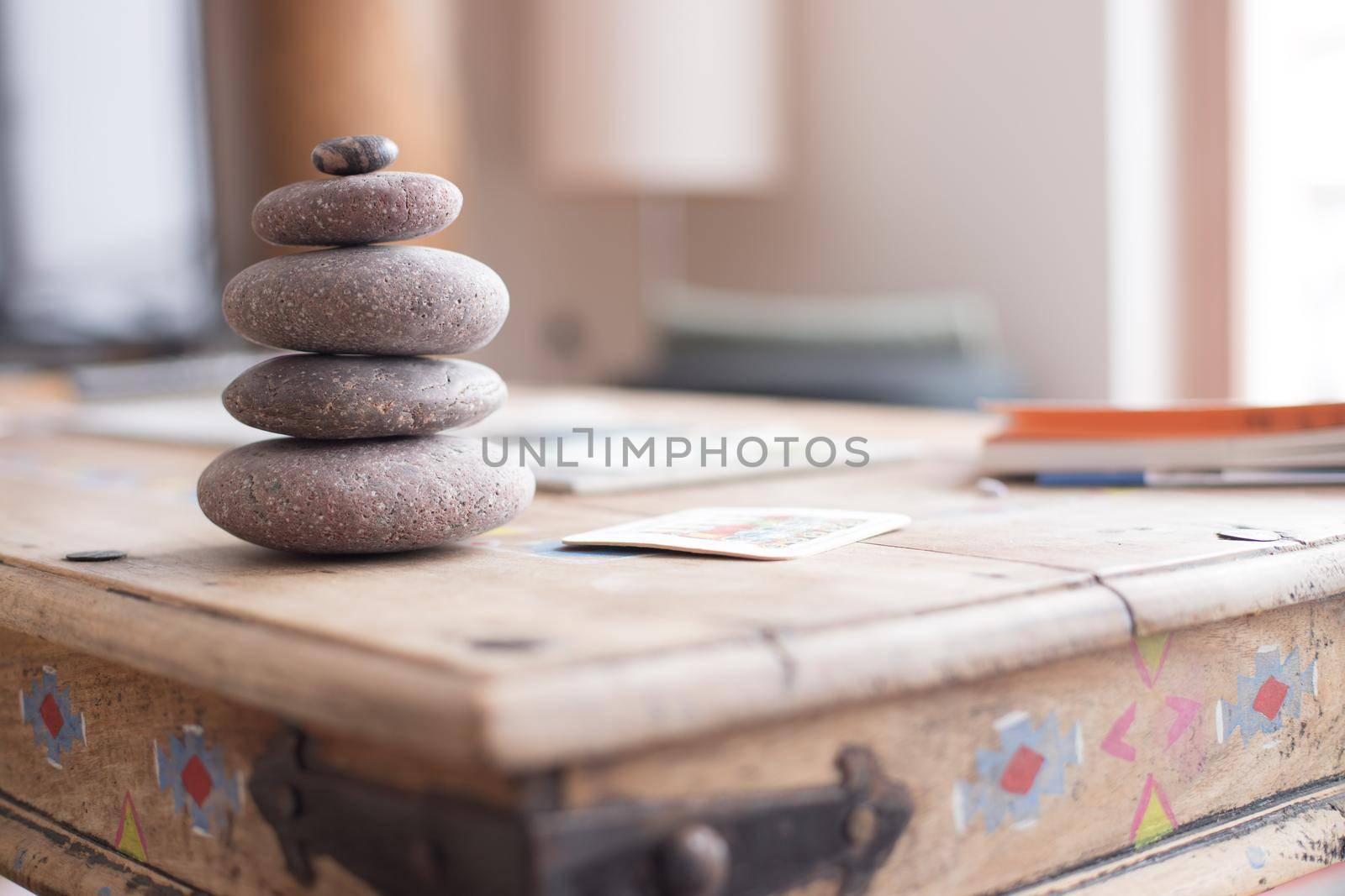 Feng Shui: Stone cairn in the foreground, blurry living room in the background. Balance and relaxation.