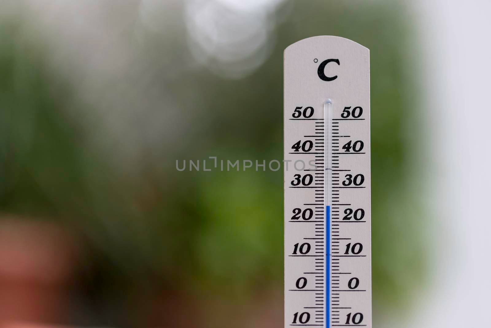 Thermometer close up picture in summer time, blurry background