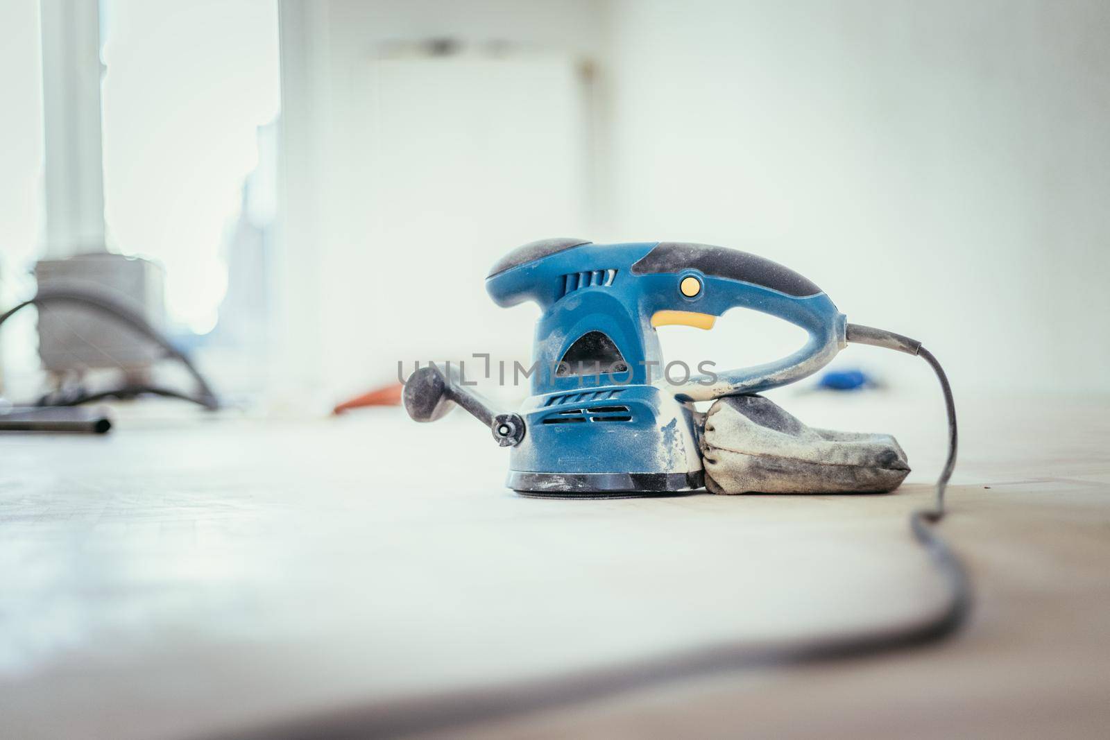 Close up of a sander power tool for DIY on wooden parquet floor