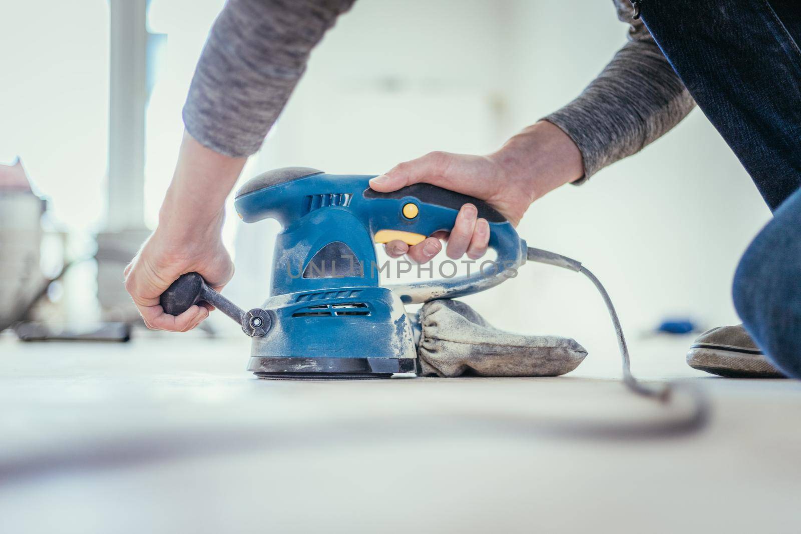 Close up of a sander power tool for DIY on wooden parquet floor