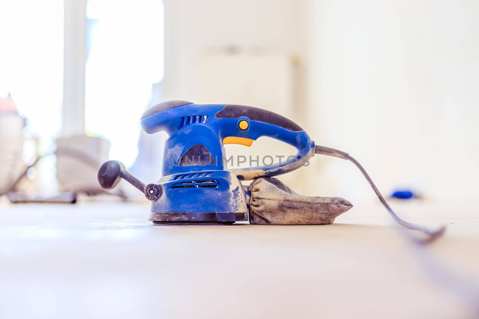 Close up of a sander power tool for DIY on wooden parquet floor