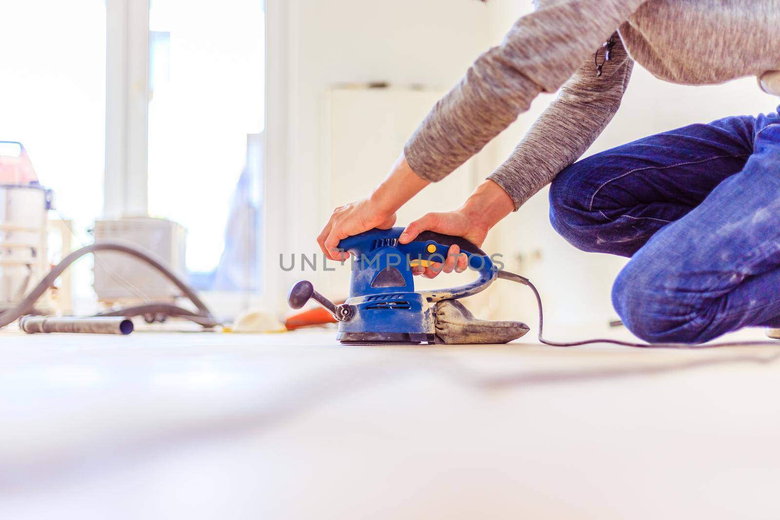 Close up of a sander power tool for DIY on wooden parquet floor