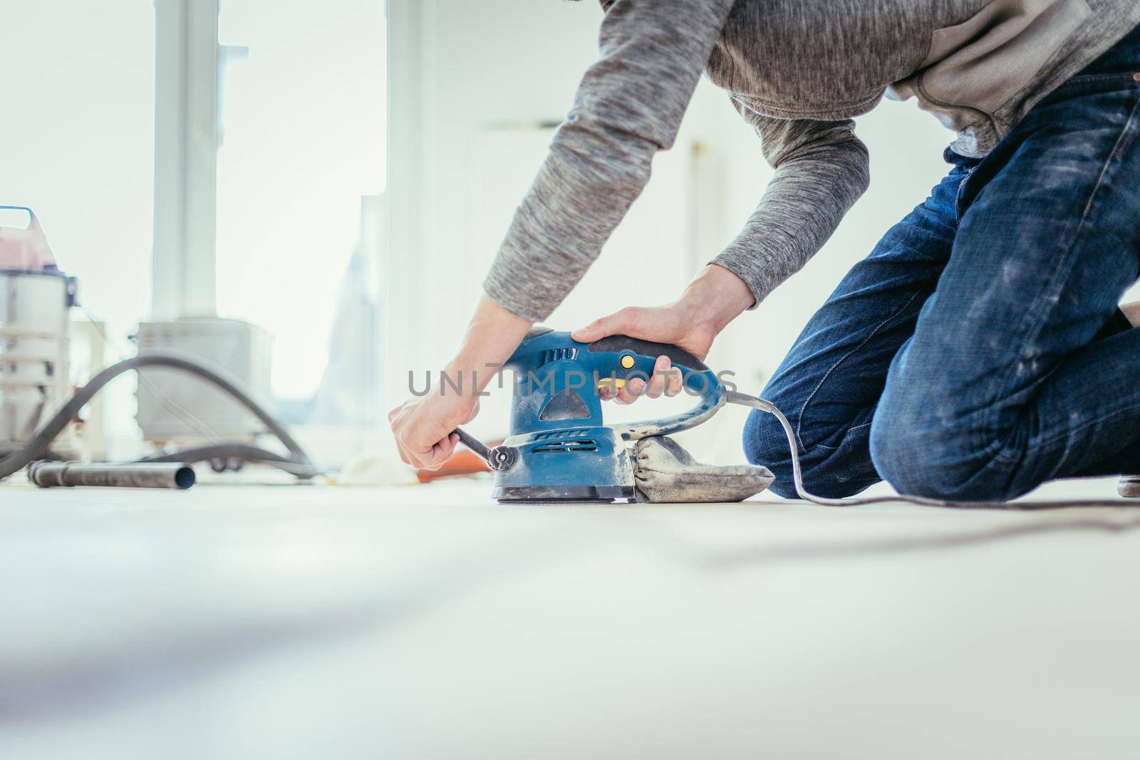 Close up of a sander power tool for DIY on wooden parquet floor