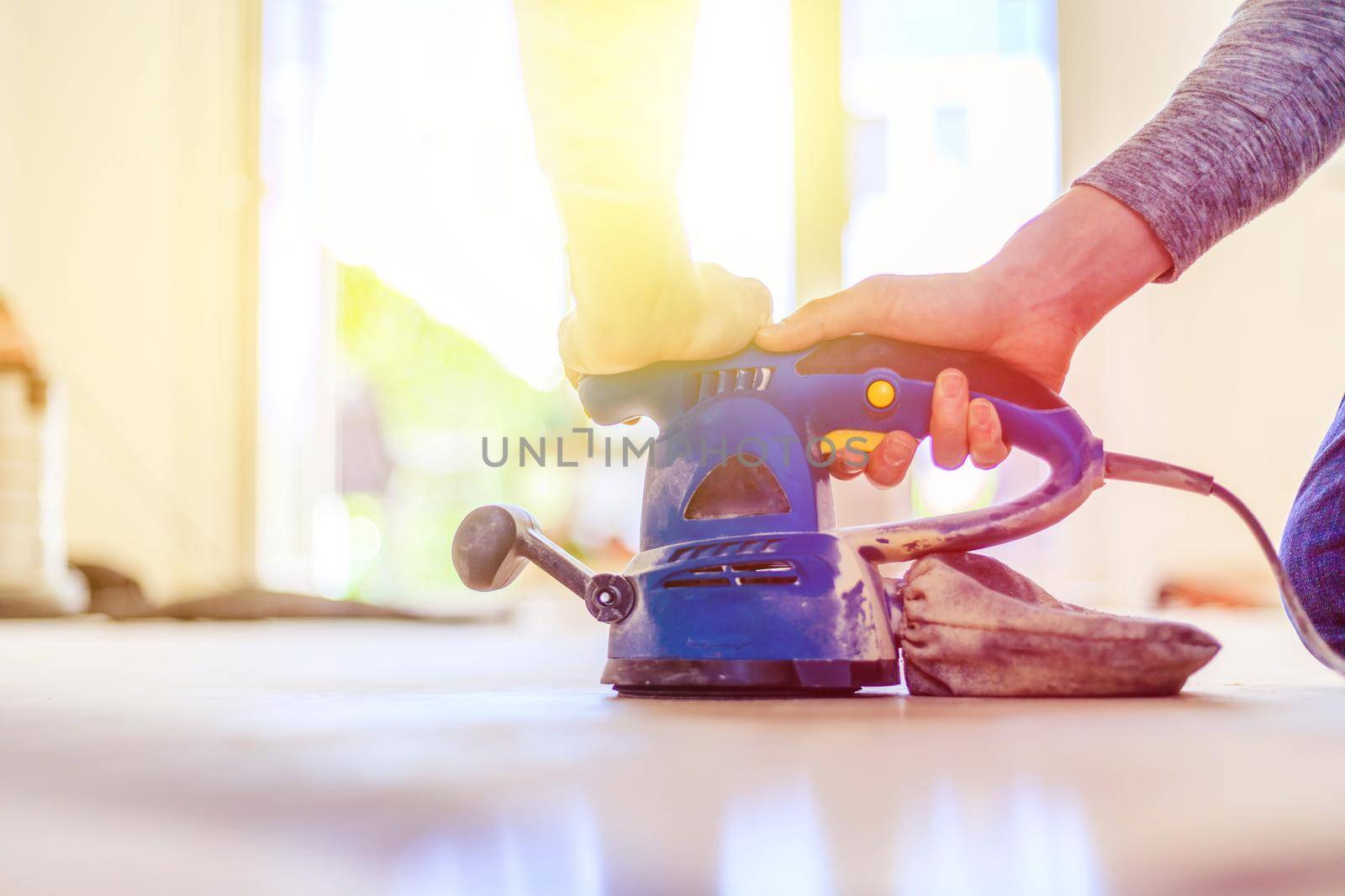 Close up of a sander power tool for DIY on wooden parquet floor