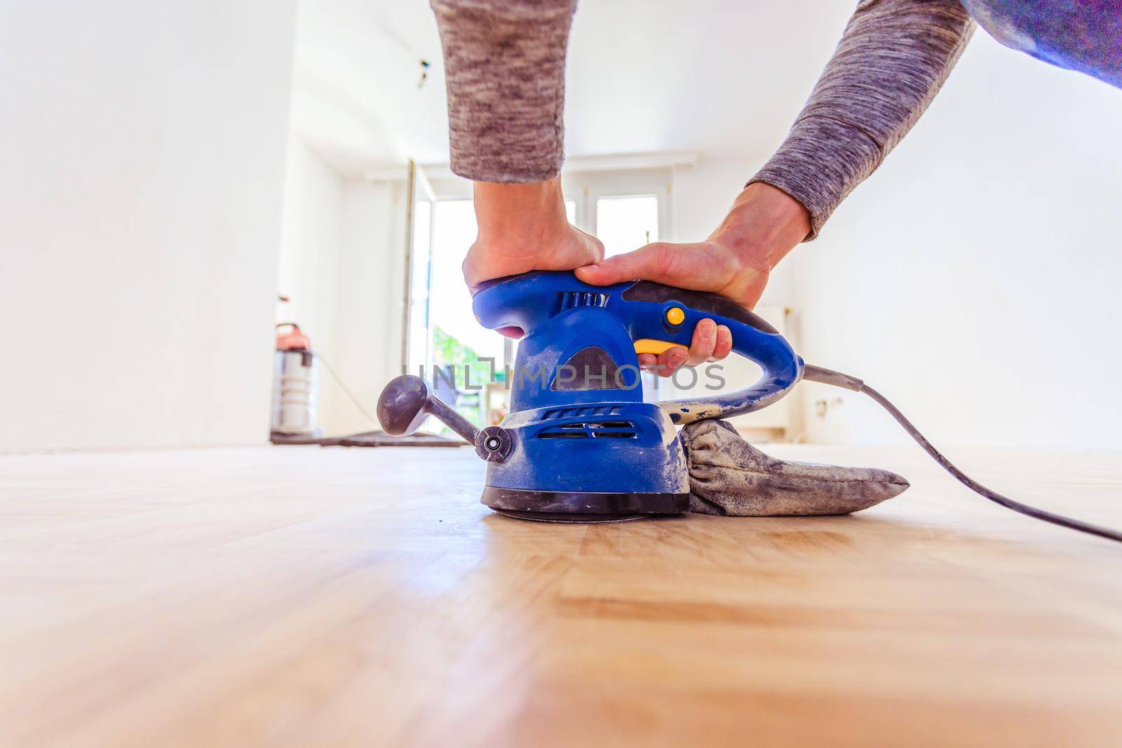 Close up of a sander power tool for DIY on wooden parquet floor