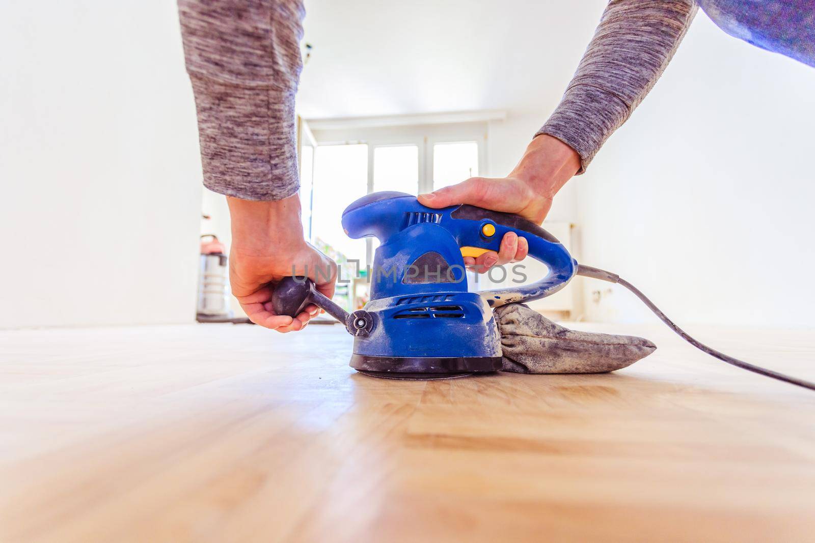 Close up of a sander power tool for DIY on wooden parquet floor