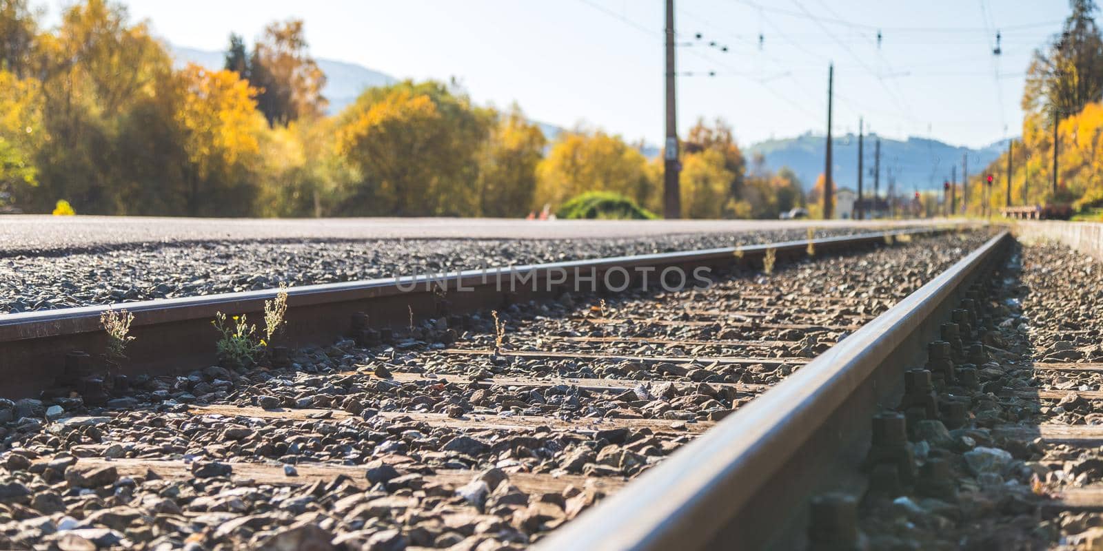 Landscape of an old abandoned railway in fall. Warm light, sustainable traveling