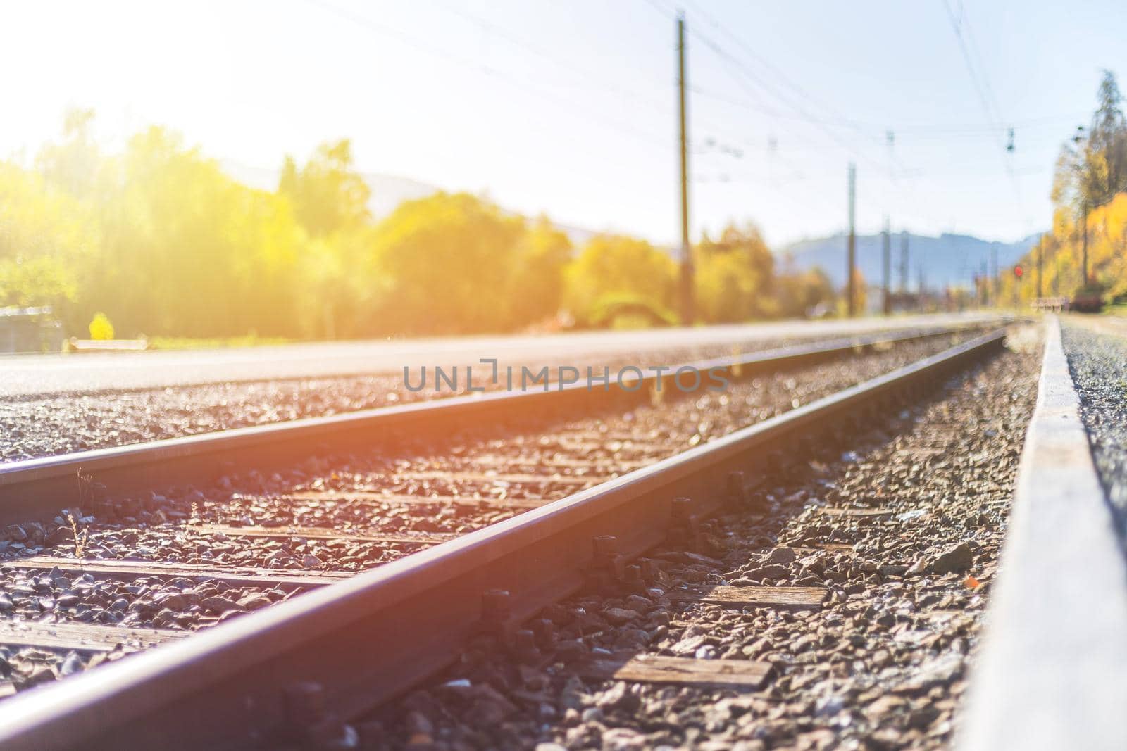 Landscape of an old abandoned railway in fall. Warm light, sustainable traveling