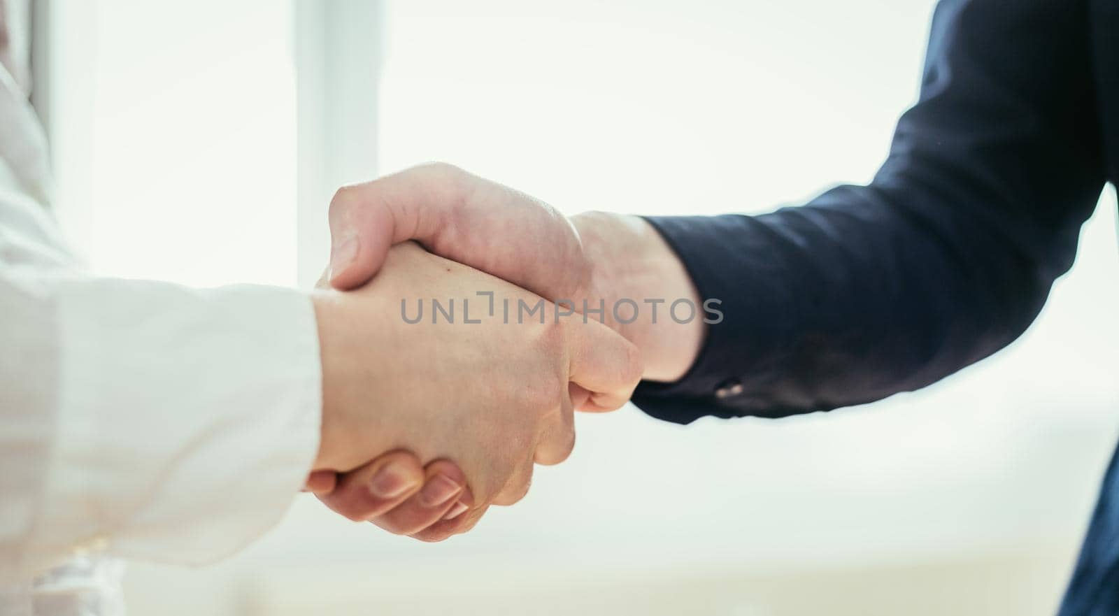 Man and woman are shaking hands, close up image, concept for human relationships