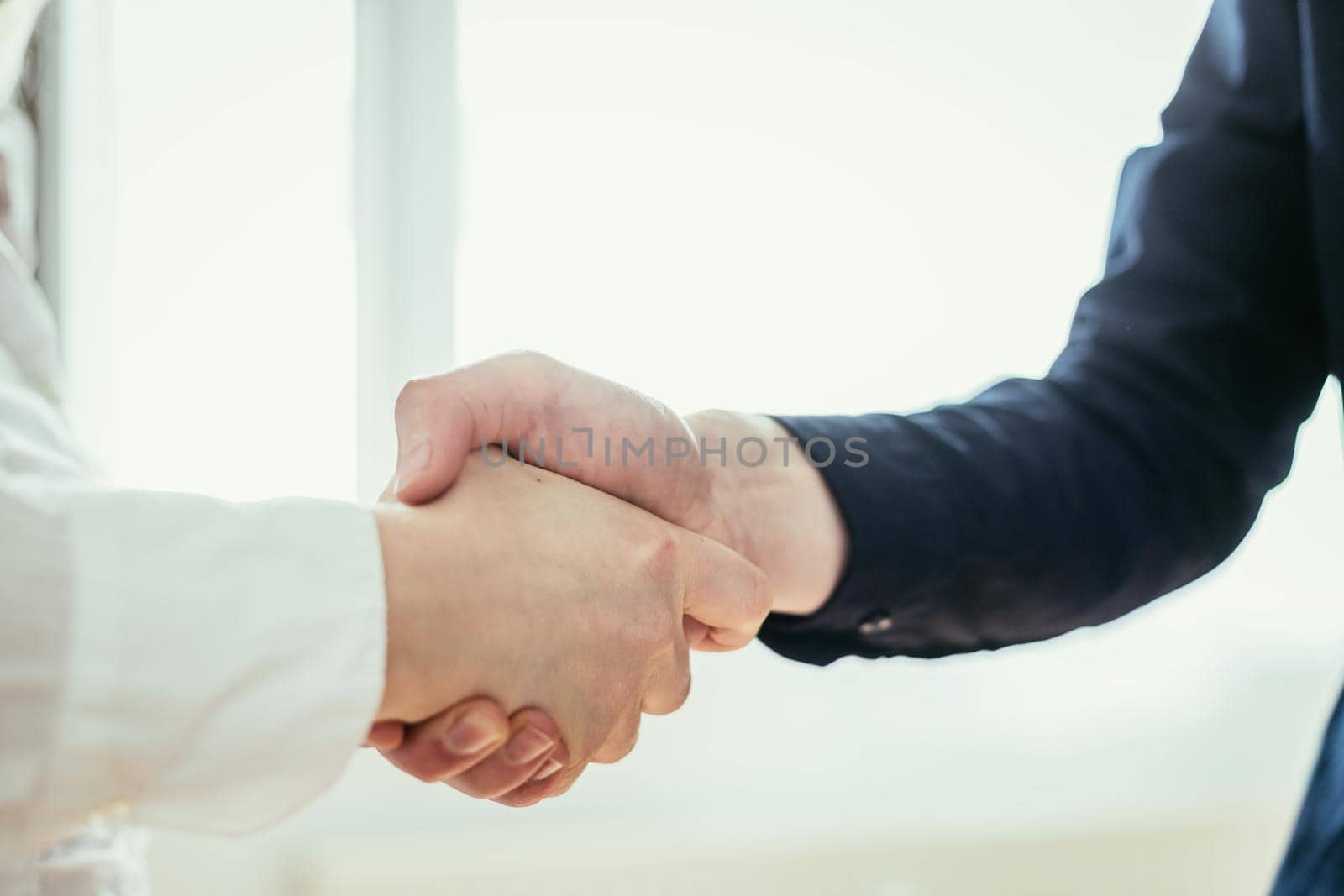 Man and woman are shaking hands, close up image, concept for human relationships