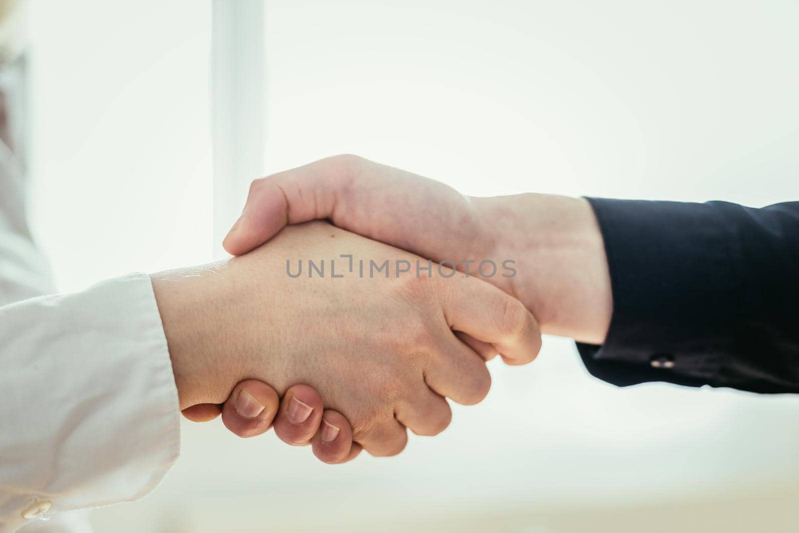 Man and woman are shaking hands, close up image, concept for human relationships