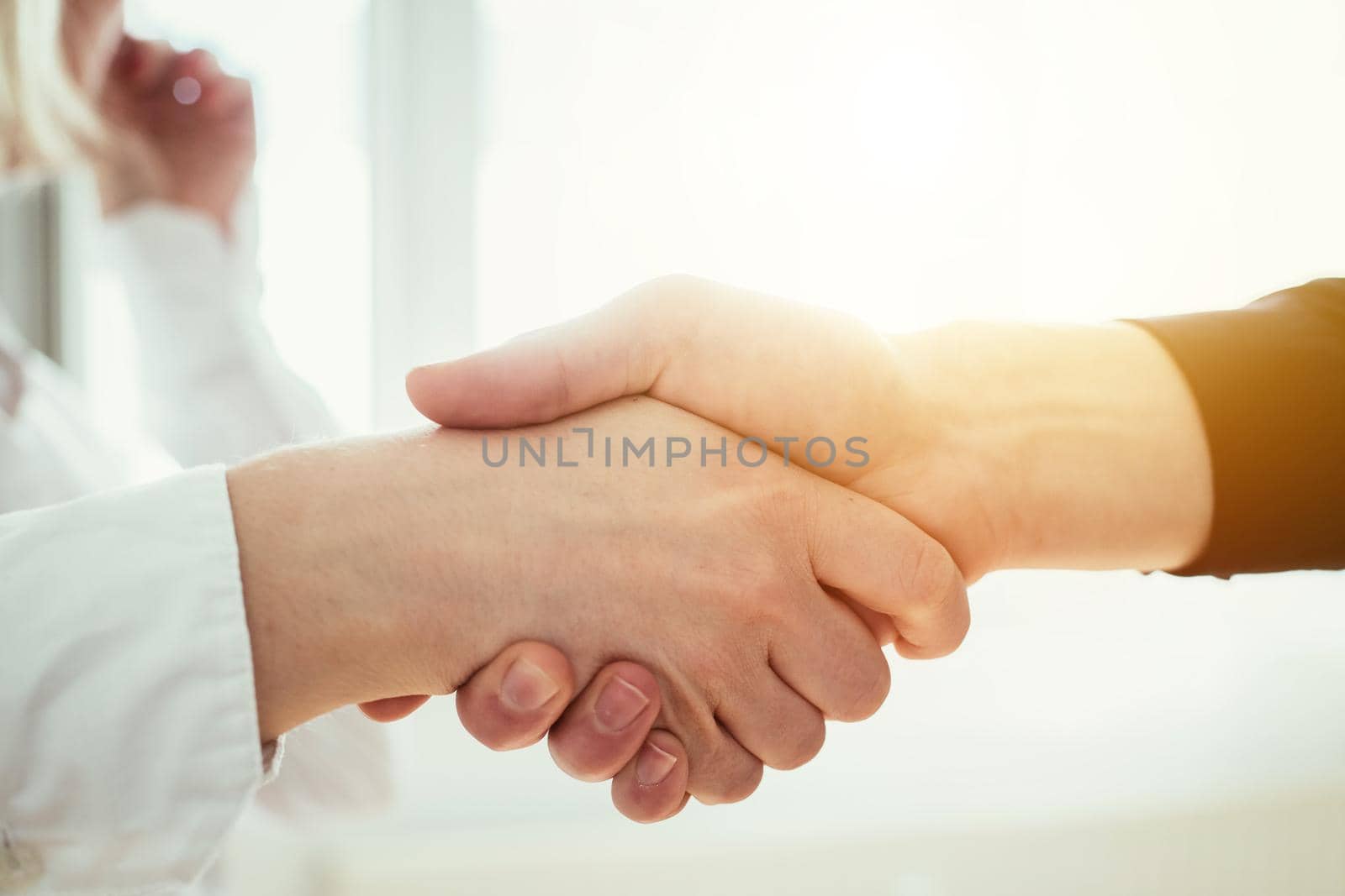 Man and woman are shaking hands, close up image, concept for human relationships