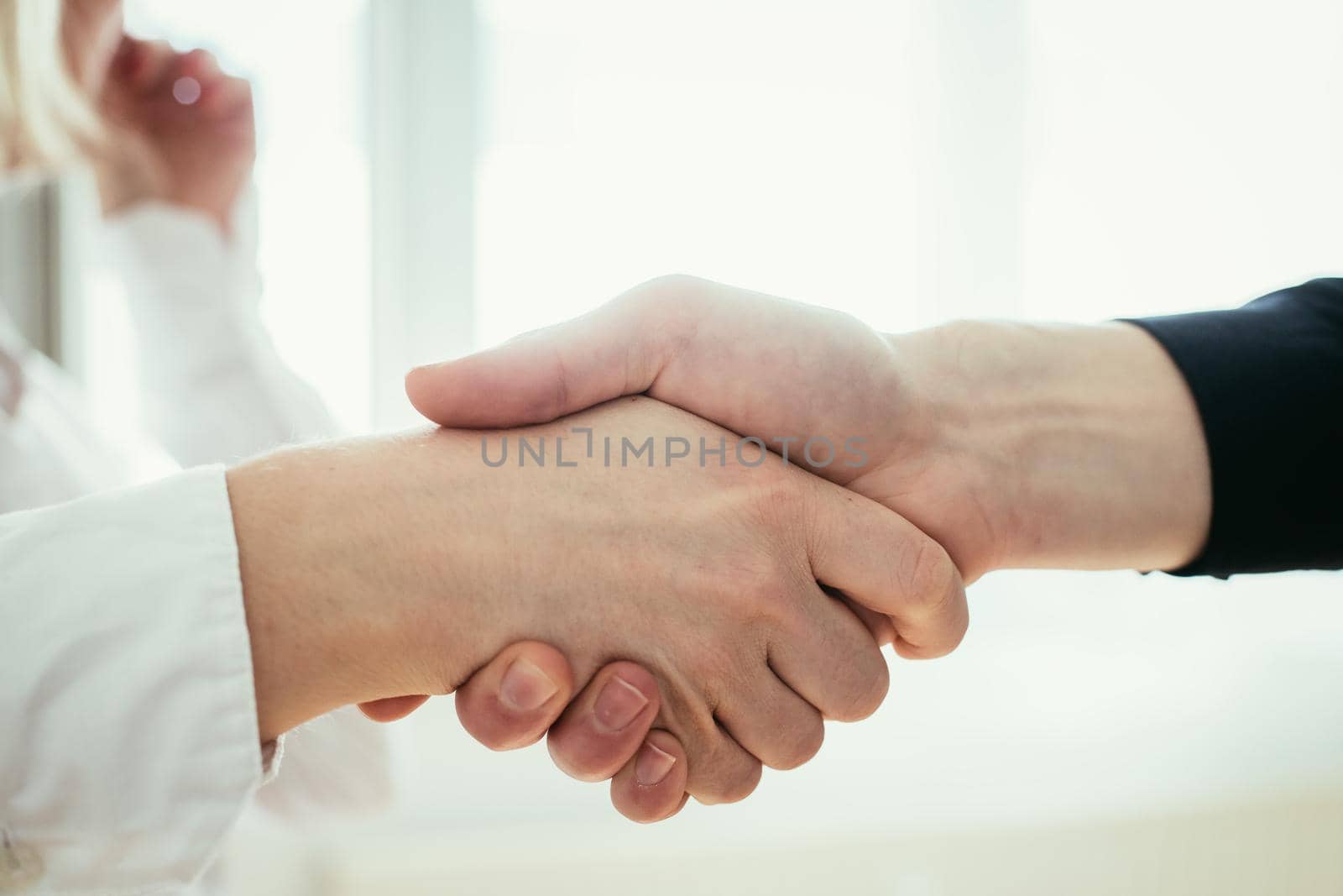 Man and woman are shaking hands, close up image, concept for human relationships