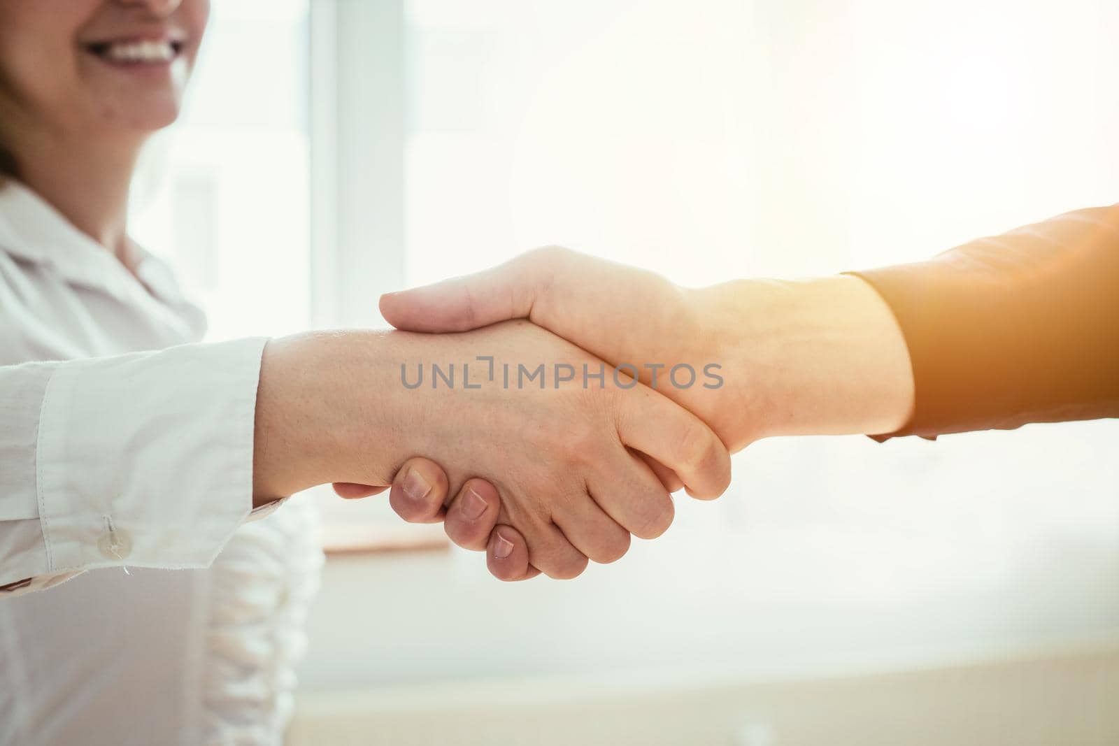 Man and woman are shaking hands, close up image, concept for human relationships