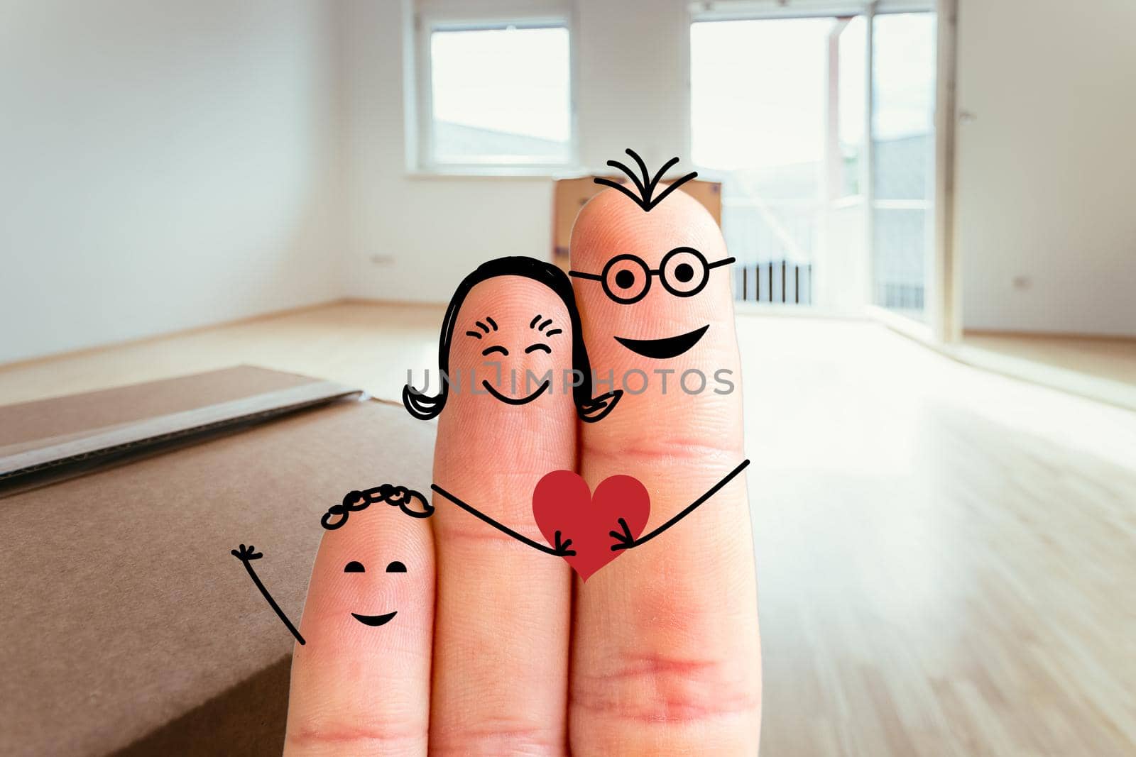 Family moving into a new home concept: Painted finger family in front of blurry bright room by Daxenbichler