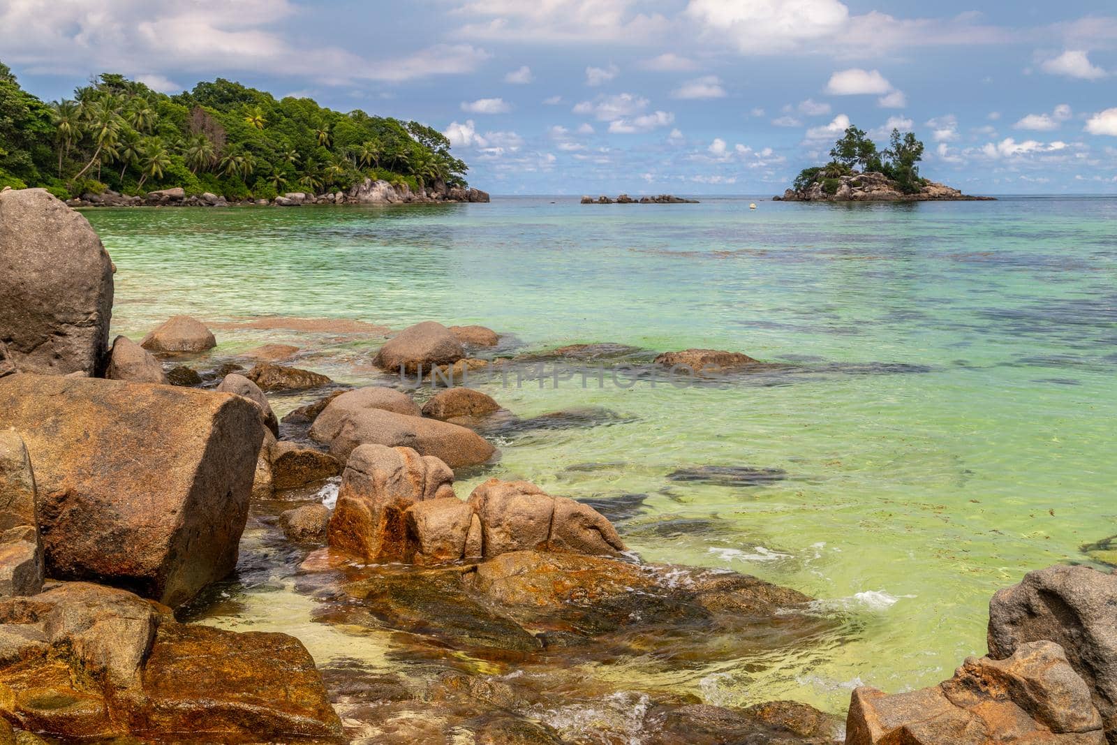 Paradise beach anse royale on Seychelles island Mahé with turguoise water, palms, white sand and granite rocks