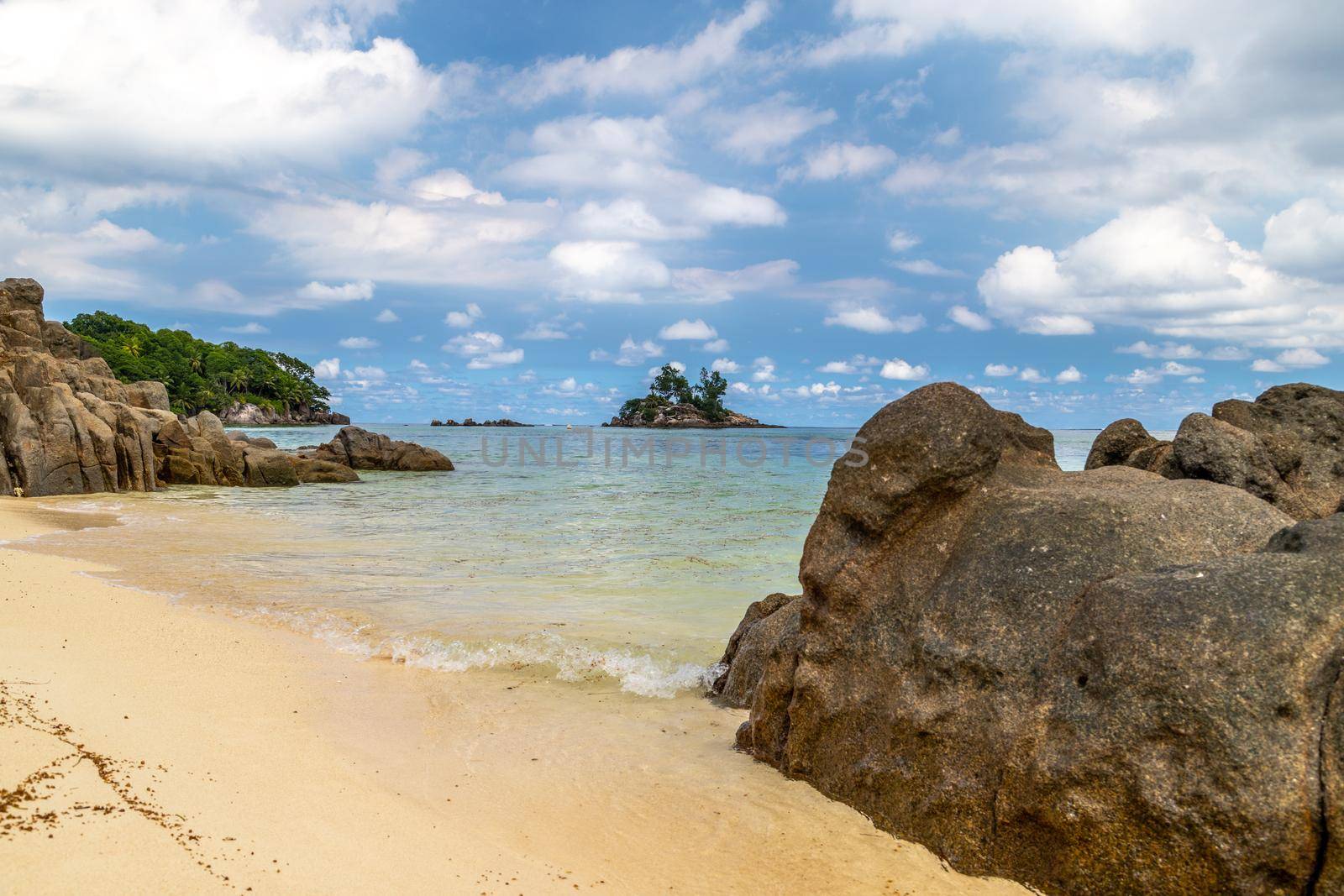 Paradise beach anse royale on Seychelles island Mahé with turguoise water, palms, white sand and granite rocks