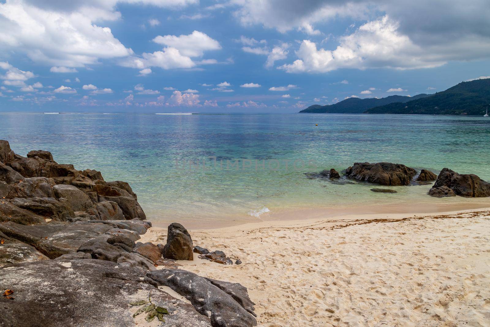 Paradise beach anse royale on Seychelles island Mahé with turguoise water, palms, white sand and granite rocks