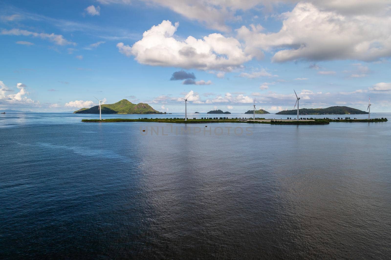 Port Victoria on Seychelles island mahé with wind wheels on an island in the background