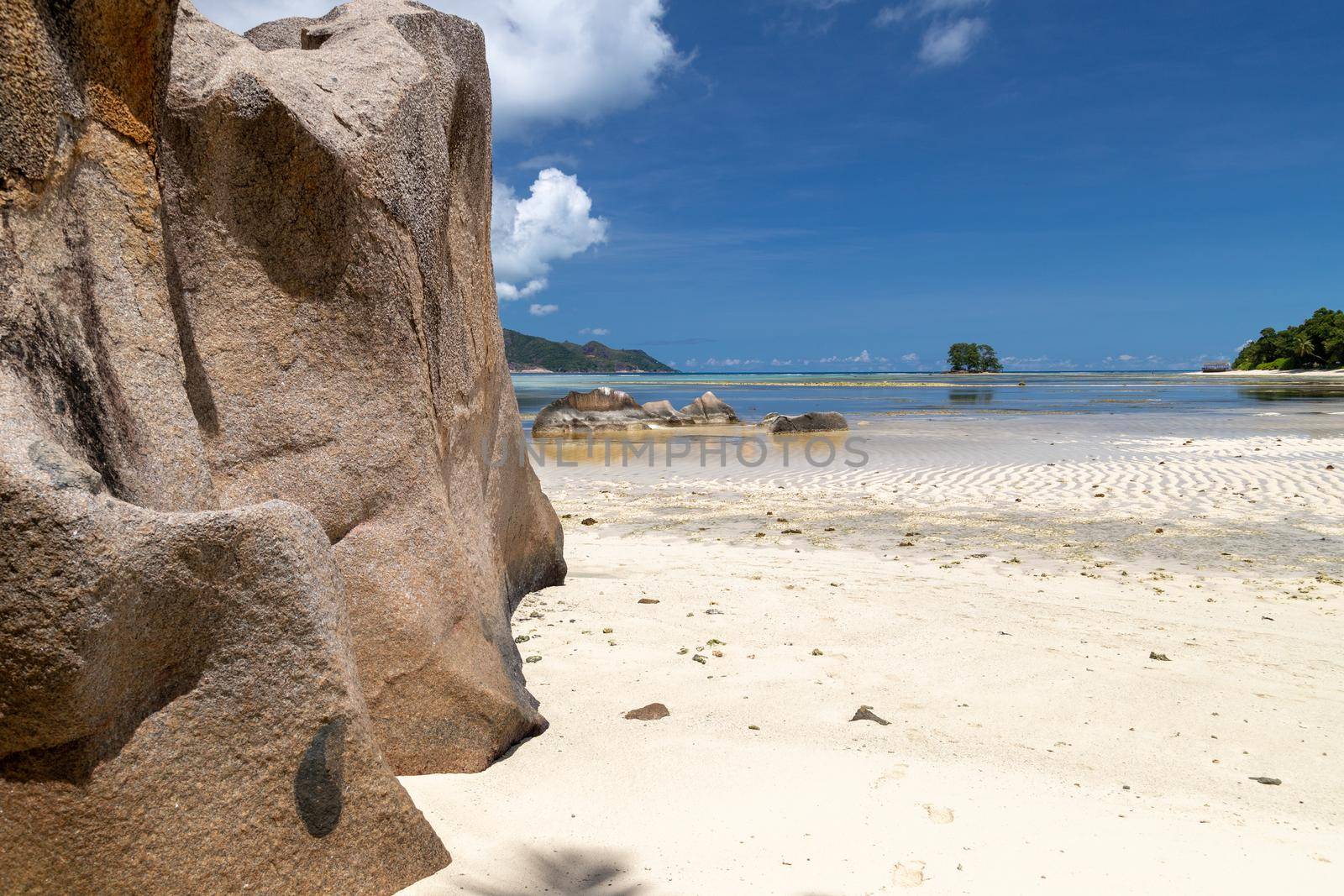 Beautiful beach Anse Source D'Argent on Seychelles island La Digue with white sand, blue water, granite rocks on the beach and blue sky with white clouds