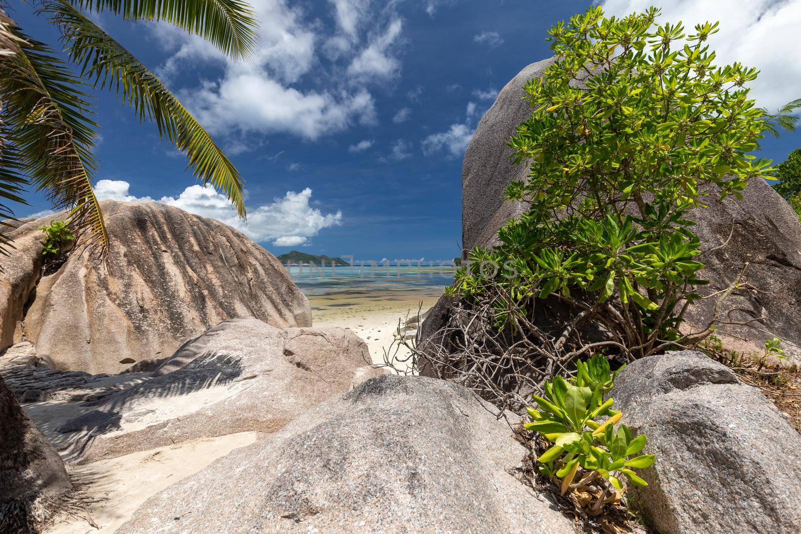 Beautiful beach Anse Source D'Argent on Seychelles island La Digue with white sand, blue water, granite rocks on the beach and blue sky with white clouds