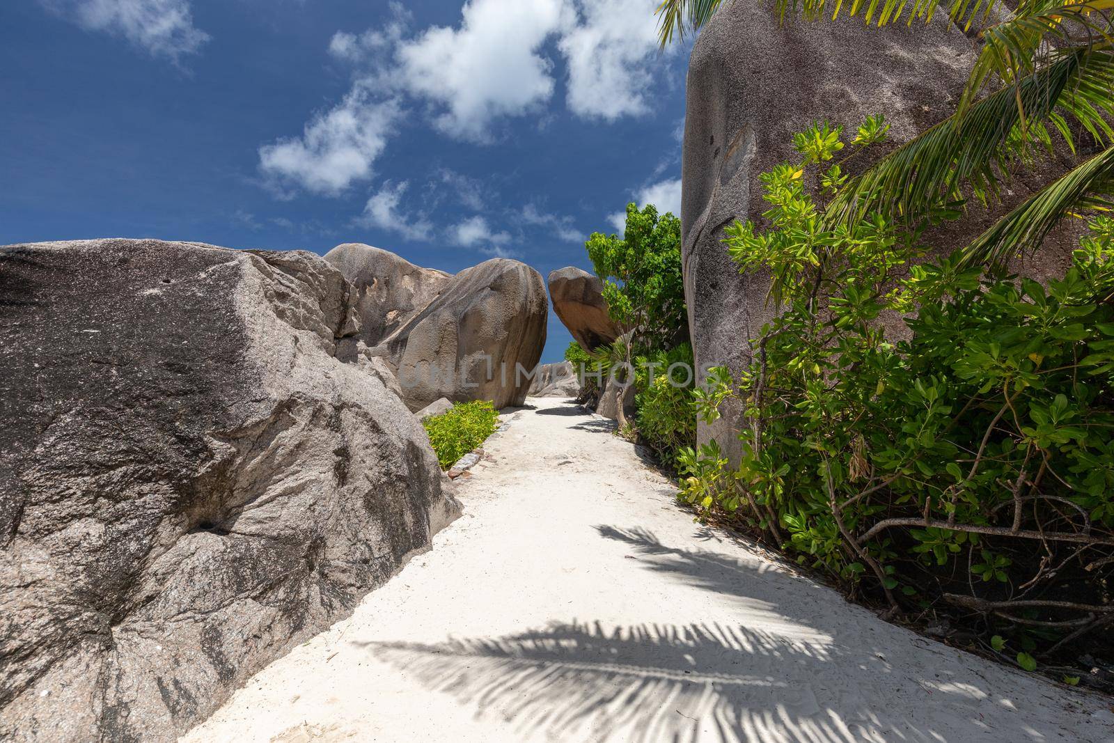 Beautiful beach Anse Source D'Argent on Seychelles island La Digue with white sand, blue water, granite rocks on the beach and blue sky with white clouds