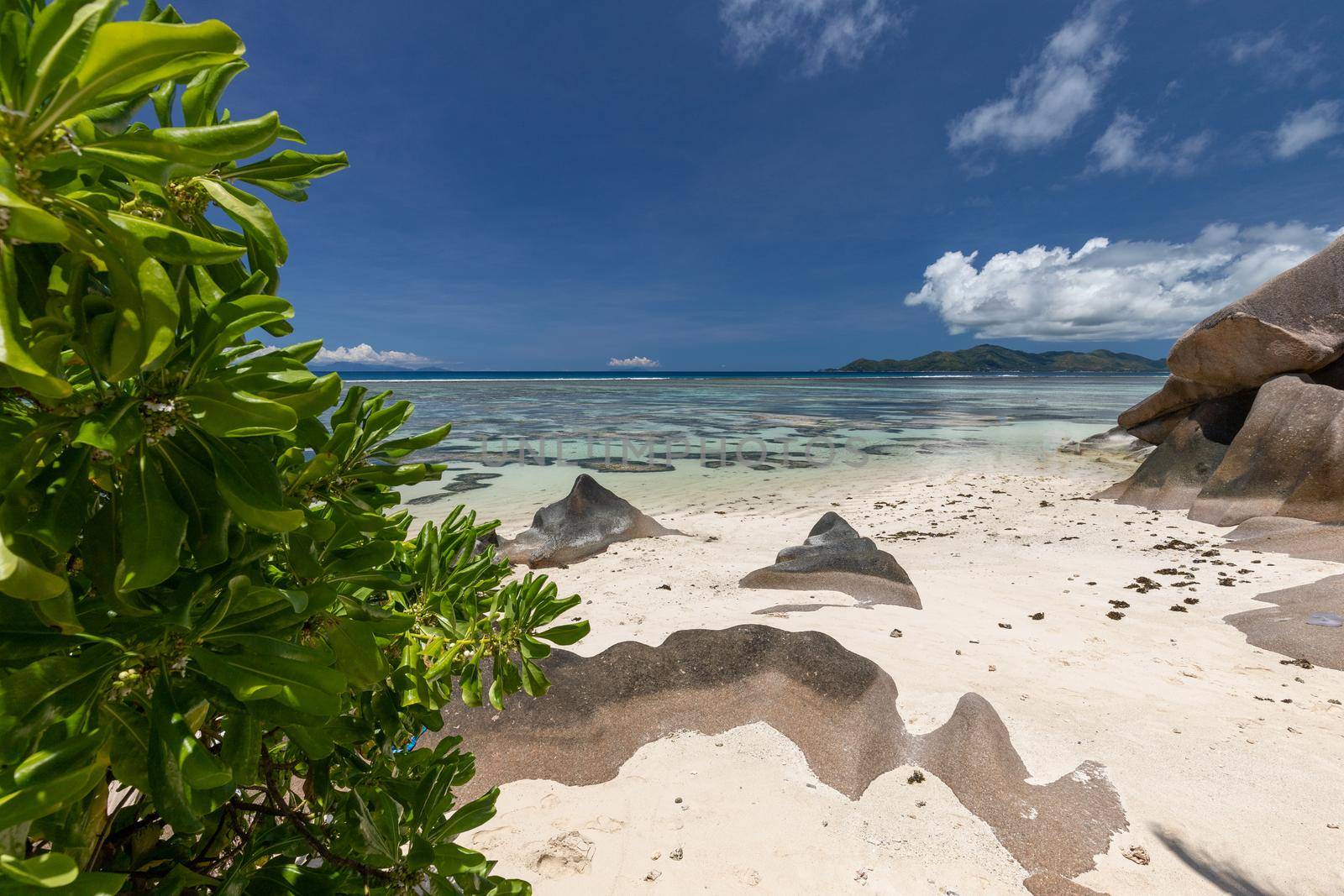 Beautiful beach Anse Source D'Argent on Seychelles island La Digue with white sand, blue water, granite rocks on the beach and blue sky with white clouds