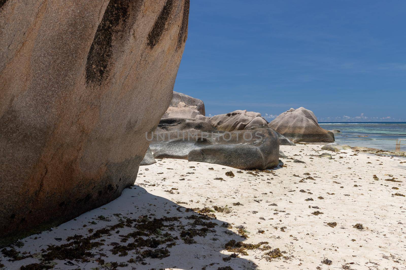 Beautiful beach Anse Source D'Argent on Seychelles island La Digue with white sand, blue water, granite rocks on the beach and blue sky with white clouds