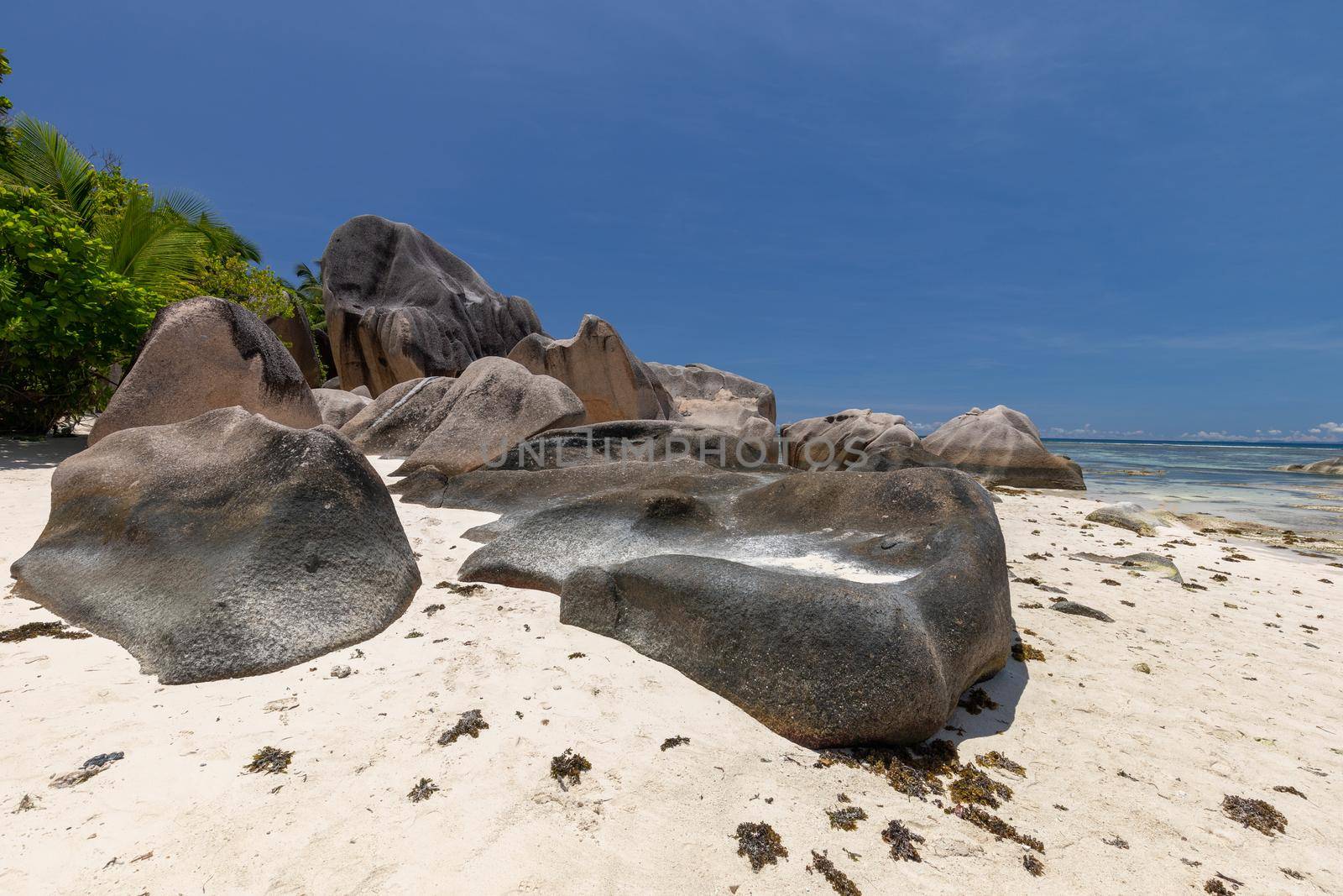 Beautiful beach Anse Source D'Argent on Seychelles island La Digue with white sand, blue water, granite rocks on the beach and blue sky with white clouds