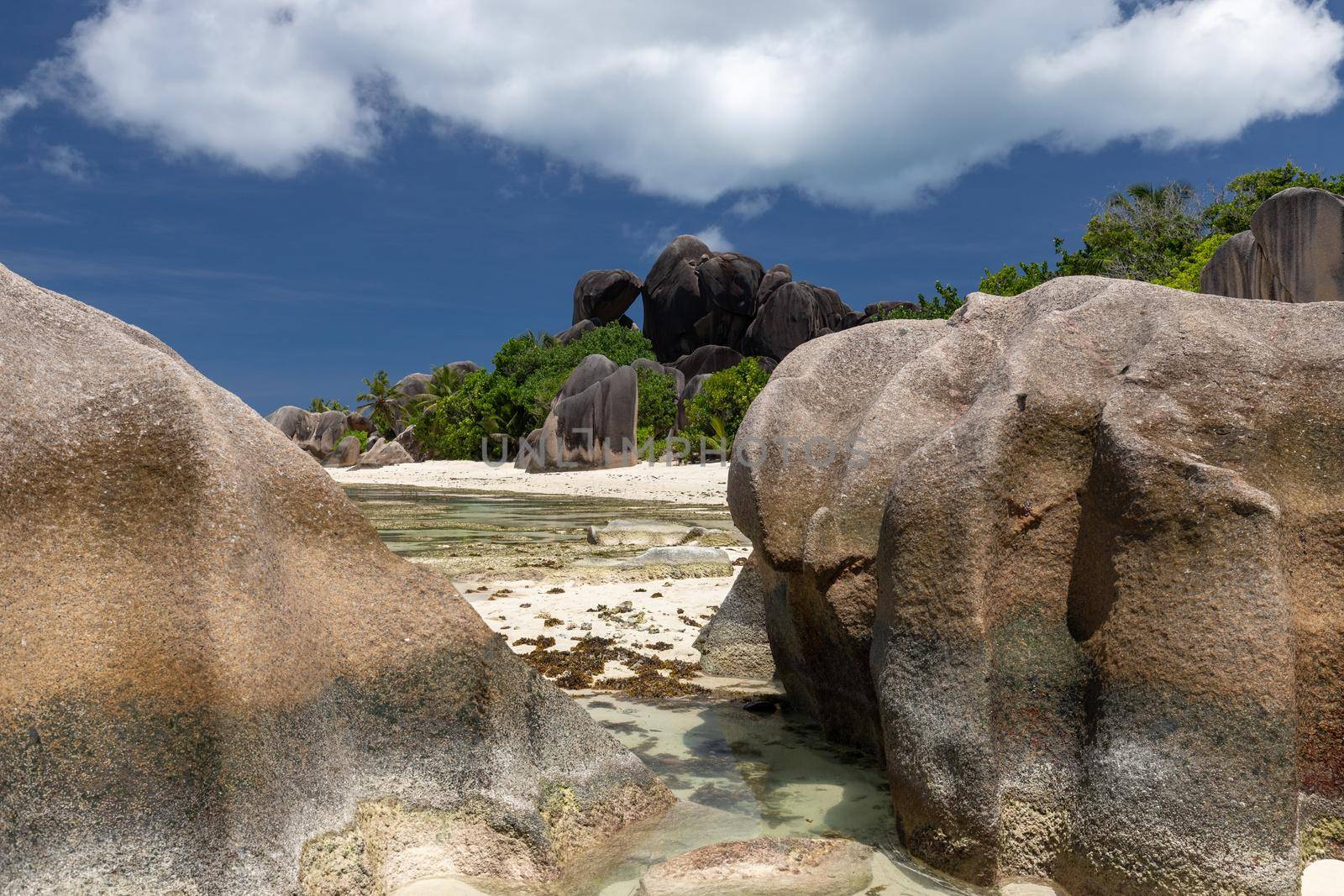 Beautiful beach Anse Source D'Argent on Seychelles island La Digue with white sand, blue water, granite rocks on the beach and blue sky with white clouds