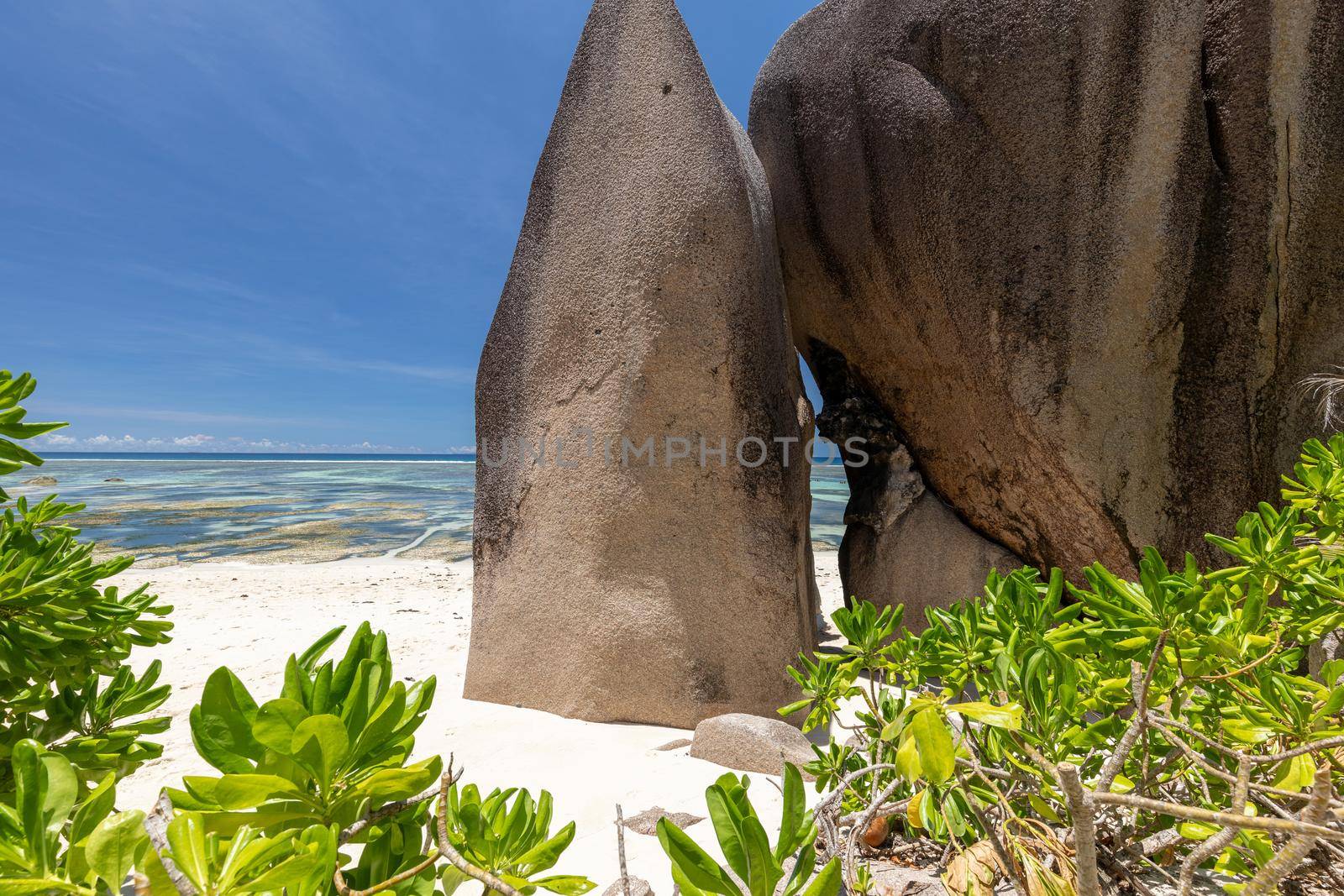 Beautiful beach Anse Source D'Argent on Seychelles island La Digue with white sand, blue water, granite rocks on the beach and blue sky with white clouds