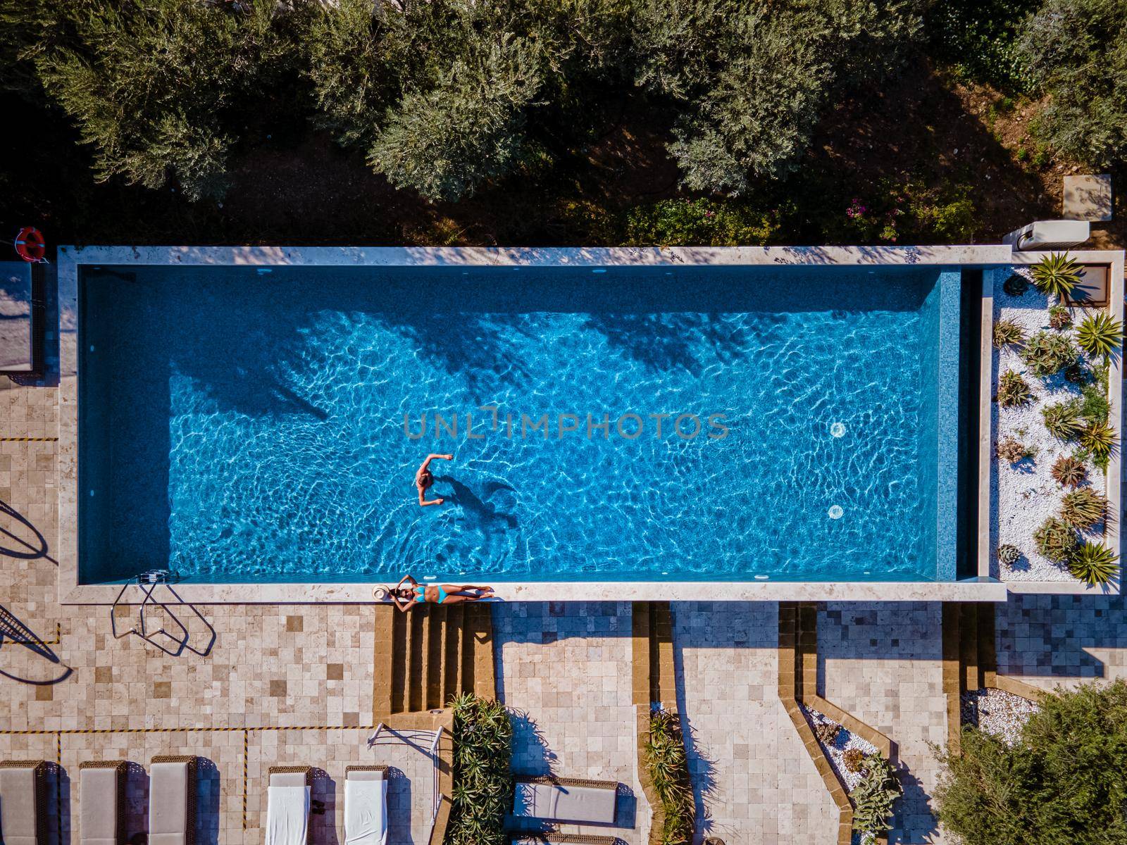 Luxury resort with a view over the wine field in Selinunte Sicily Italy. infinity pool with a view over wine fields in Sicilia, a couple on luxury vacation at the Island of Sicily Italy