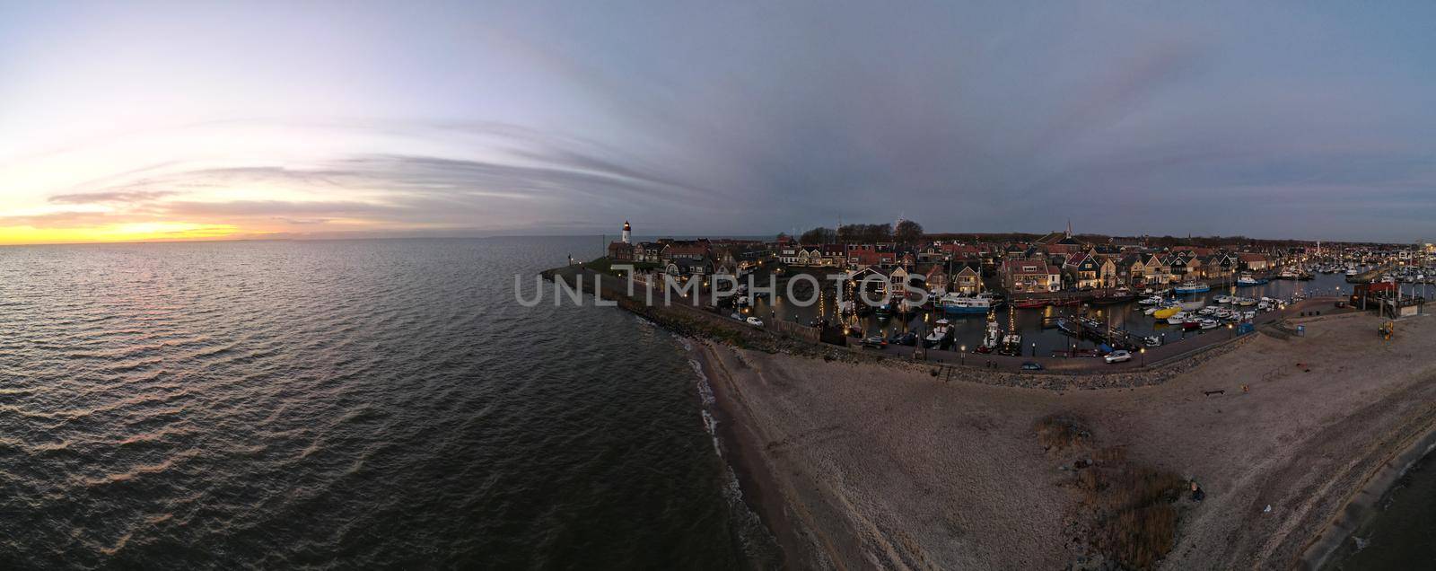 Urk lighthouse with old harbor during sunset, Urk is a small village by the lake Ijsselmeer in the Netherlands Flevoland area by fokkebok