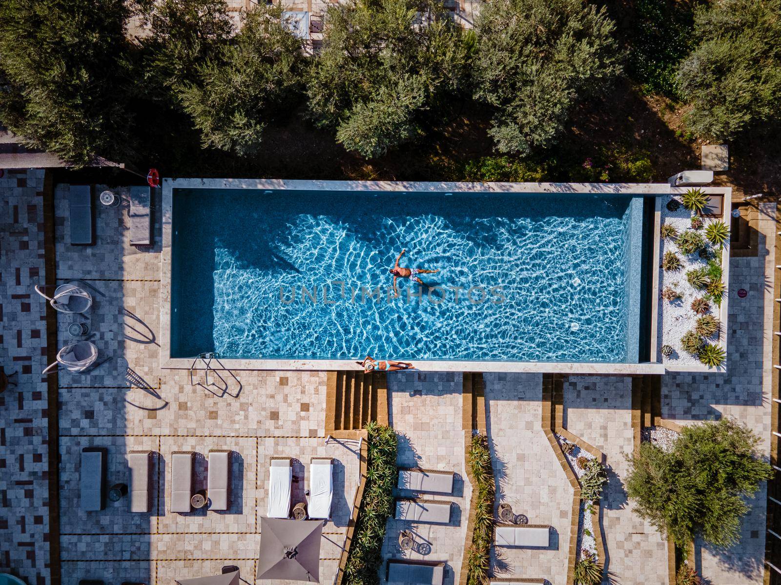 Luxury resort with a view over the wine field in Selinunte Sicily Italy. infinity pool with a view over wine fields in Sicilia, a couple on luxury vacation at the Island of Sicily Italy