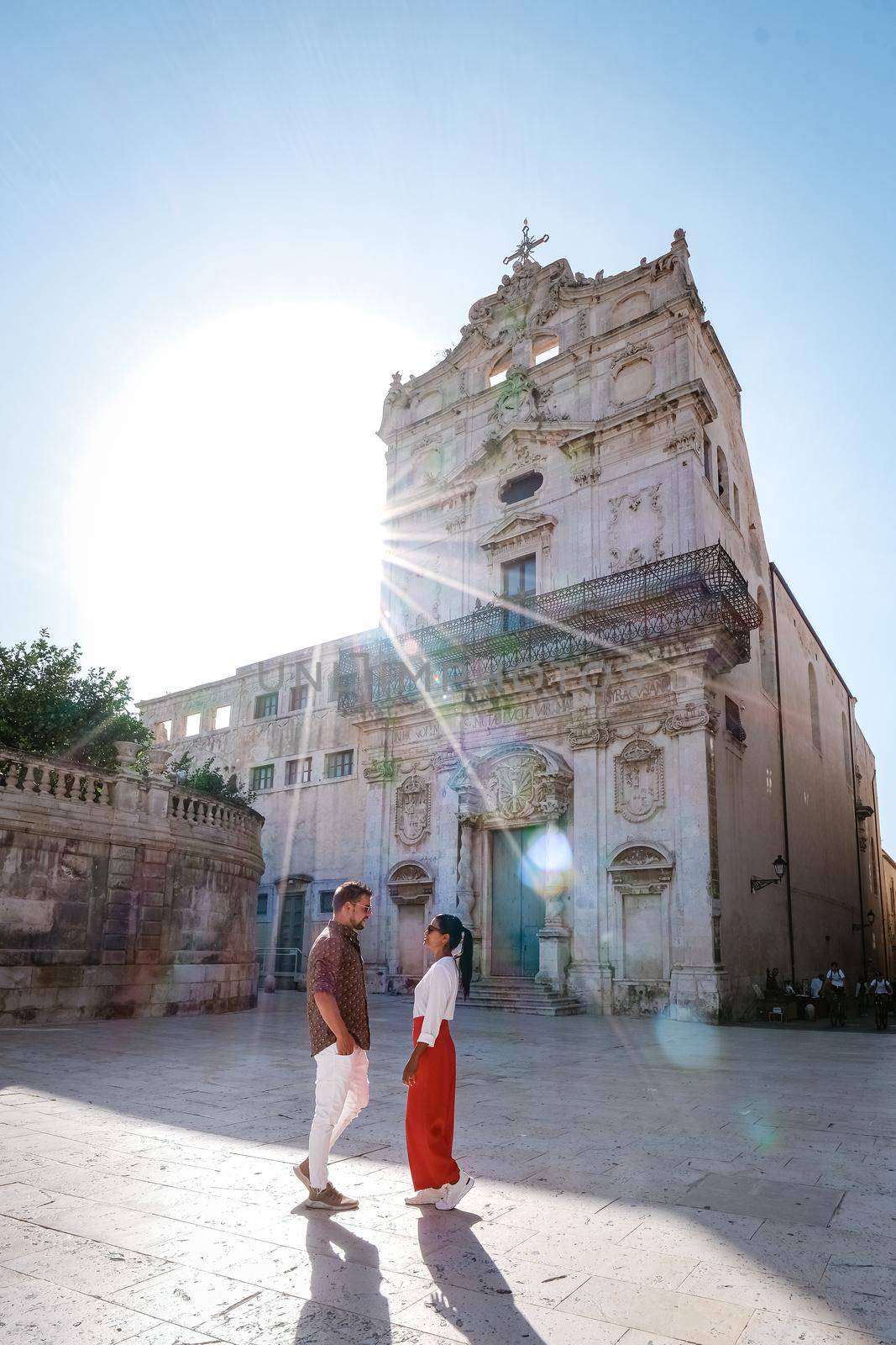 couple men and woman on citytrip, Ortigia in Syracuse Sicily Italy in the Morning. Travel Photography from Syracuse, Italy on the island of Sicily. 