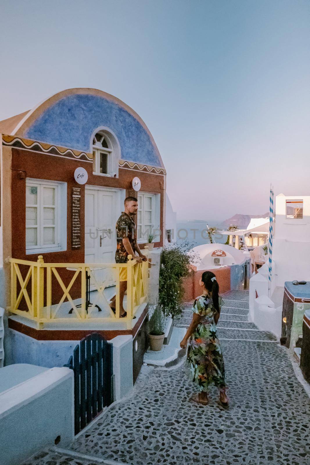 Santorini Greece August 2020, streets of Oia on a early morning with cafe and restaurant by fokkebok