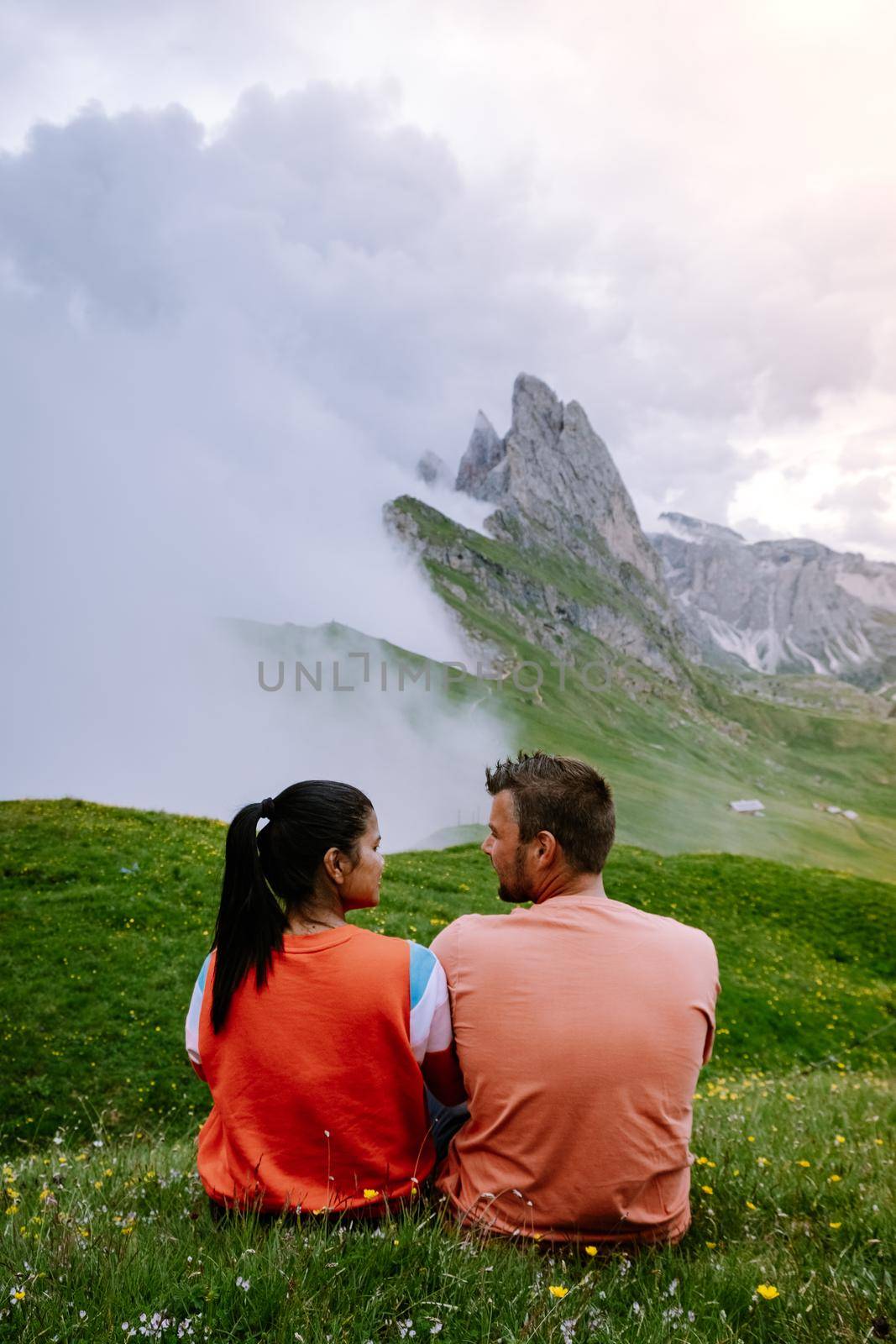 couple on vacation hiking in the Italien Dolomites, Amazing view on Seceda peak. Trentino Alto Adige, Dolomites Alps, South Tyrol, Italy, by fokkebok