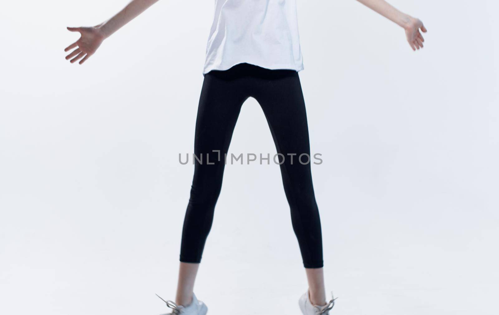 Energetic woman in sportswear on a light background fun emotions model by SHOTPRIME