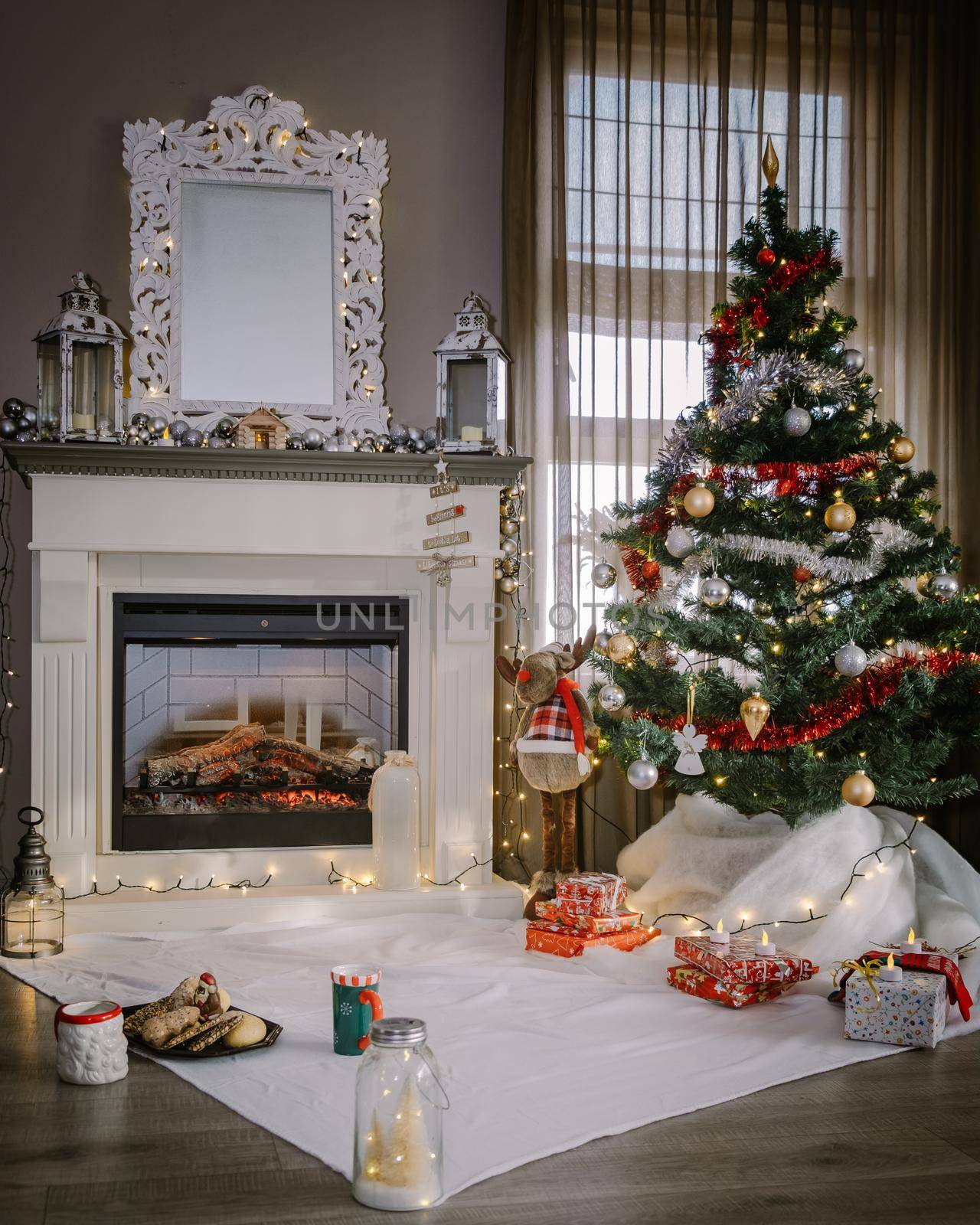 Christmas tree and fireplace, Christmas socks and hot chocolate cups by fireplace during Christmas holiday