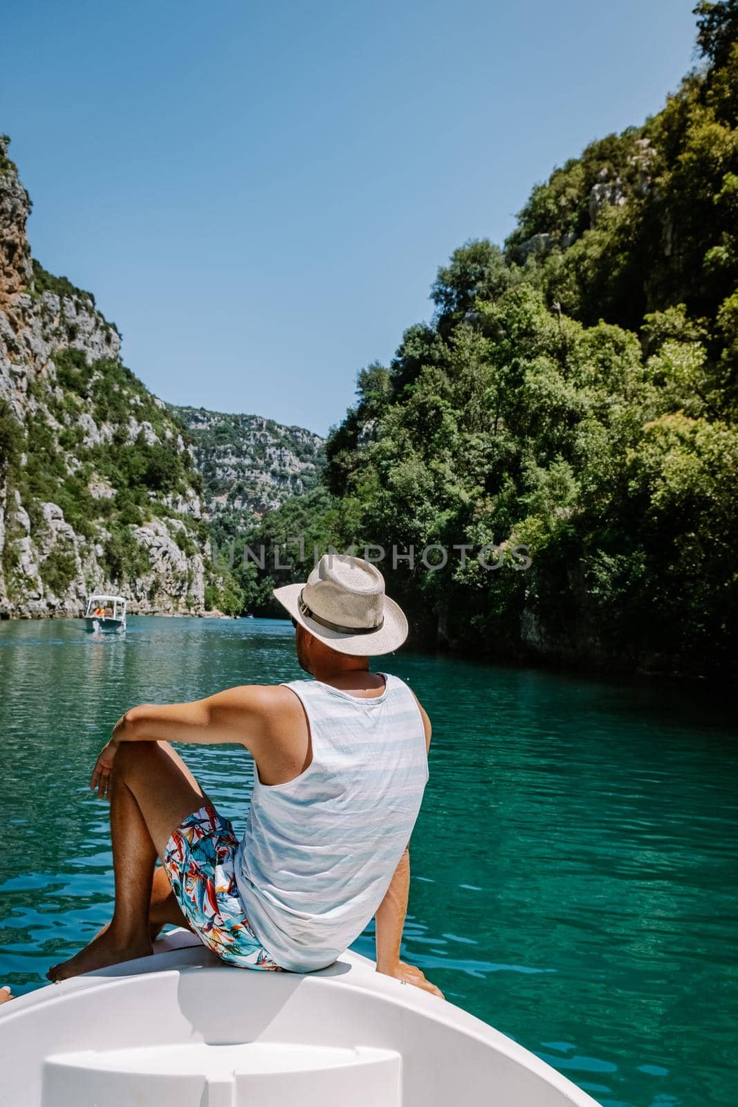 young men view to the cliffy rocks of Verdon Gorge at lake of Sainte Croix, Provence, France, near Moustiers Sainte Marie, department Alpes de Haute Provence, region Provence Alpes Cote Azur by fokkebok