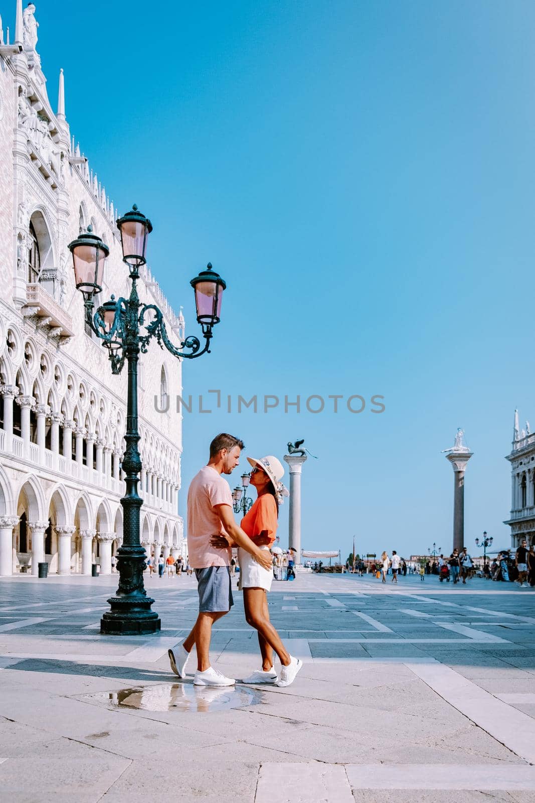 couple men and woman on a city trip to Venice Italy, colorful streets with canals Venice. Europe