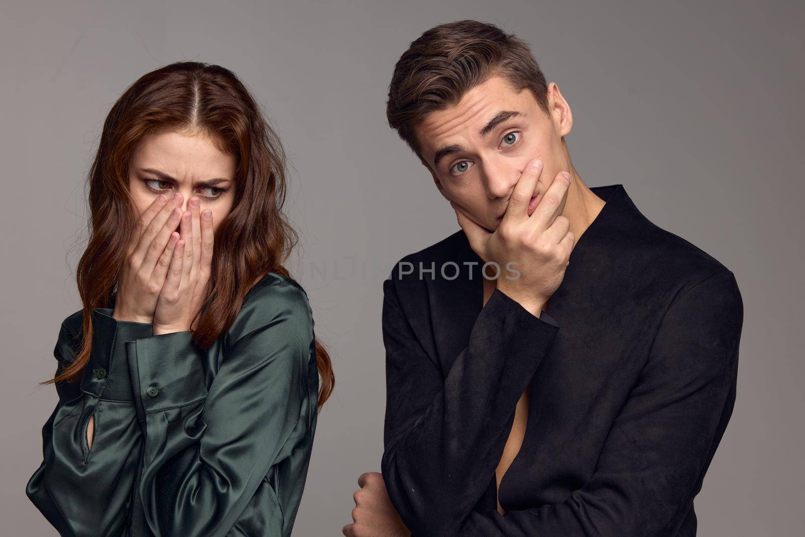 The woman covered her mouth with her hands and turned away from the surprised man. High quality photo