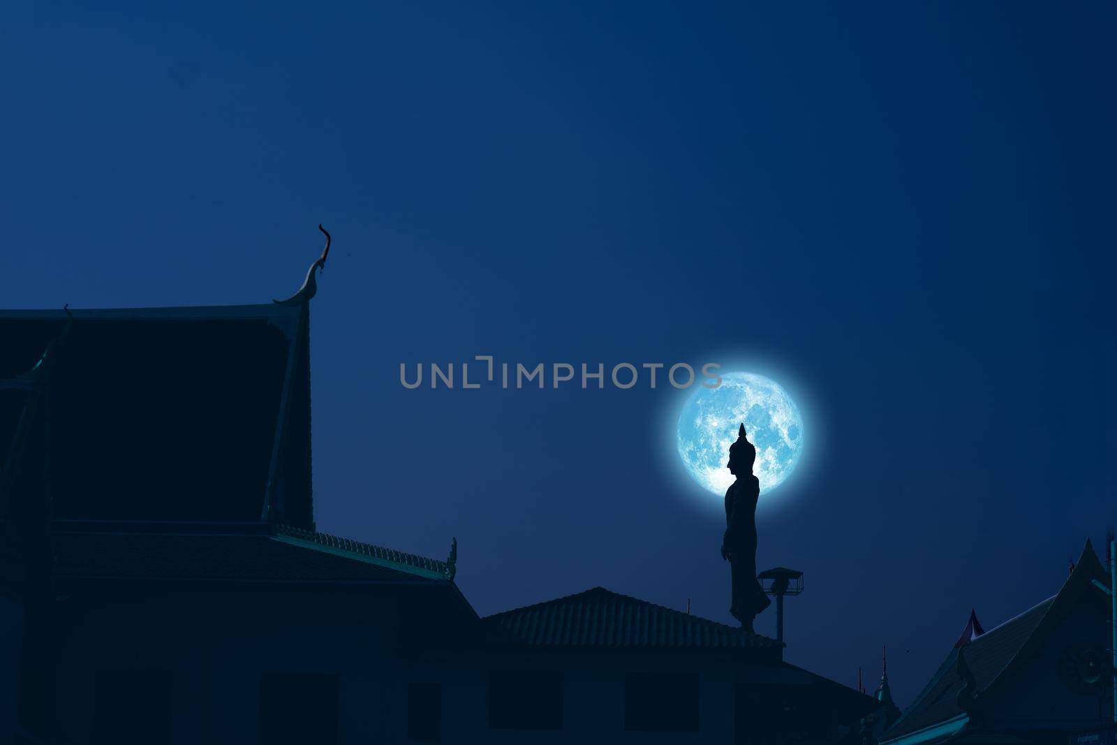 Sunday Buddha and blue moon on night sky in the Asanha bucha day, Elements of this image furnished by NASA