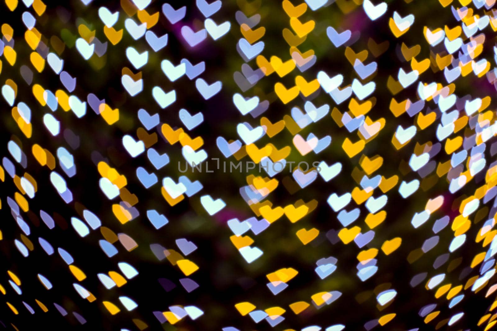 gold yellow blur heart shape love valentine day night light on tree in garden