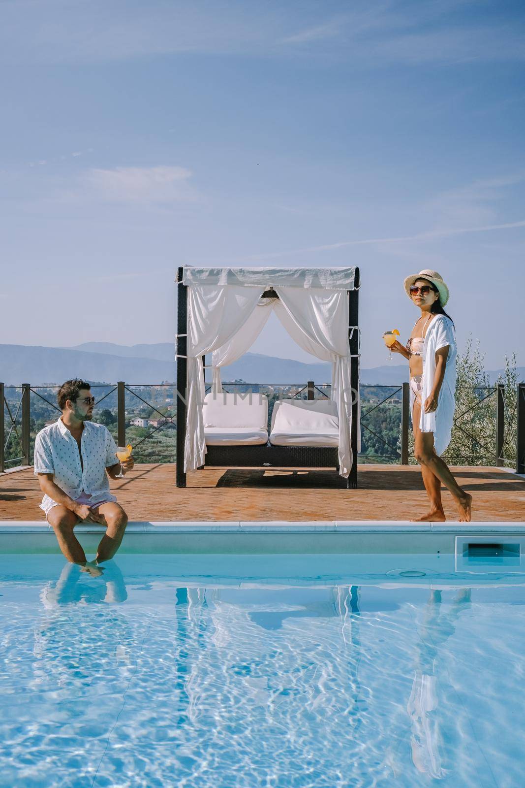 Luxury country house with swimming pool in Italy, Couple on Vacation at luxury villa in Italy, men and woman watching sunset by fokkebok